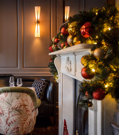 The garlanded fireplace at The Grayson at Christmas