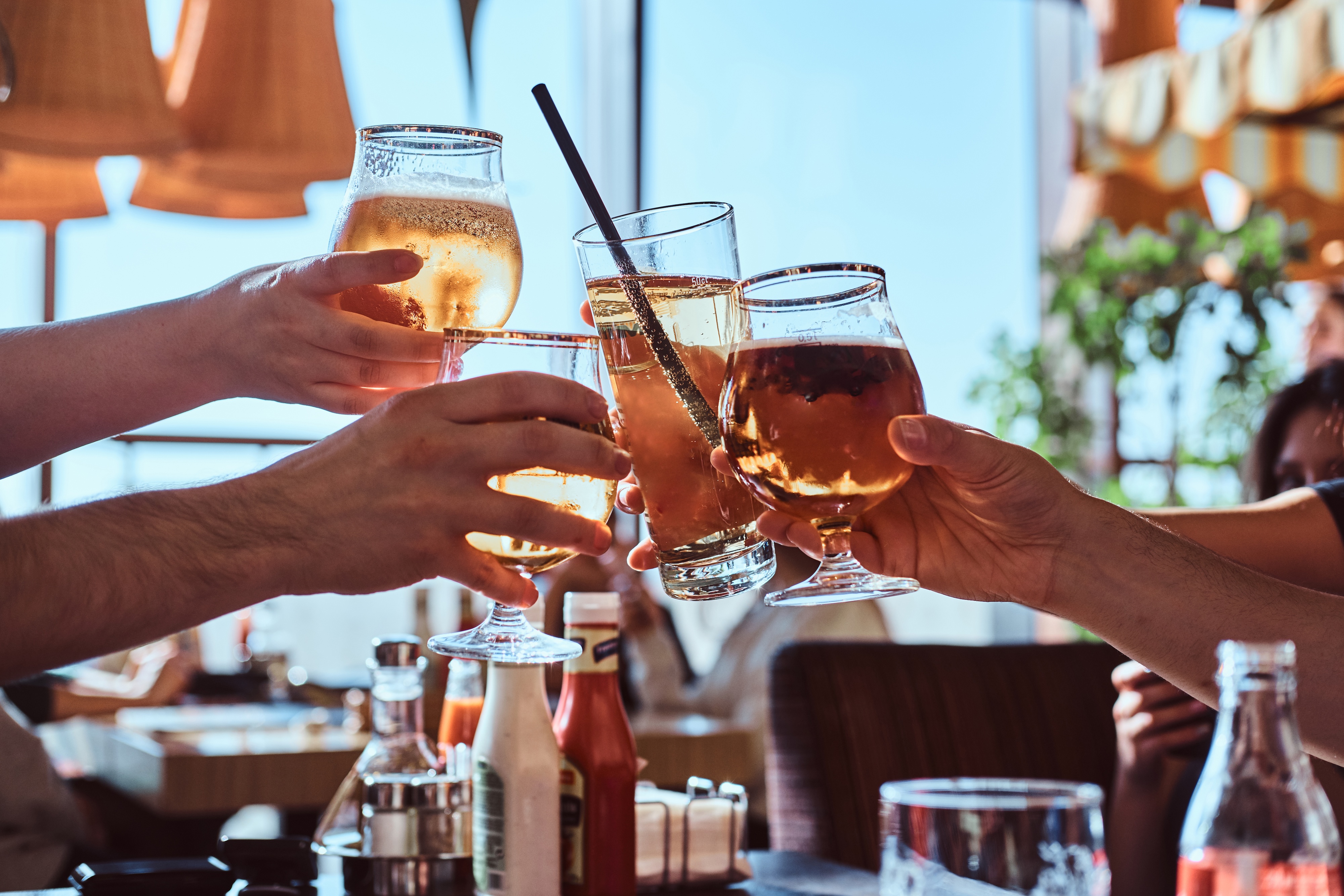 People cheersing their drinks stock image