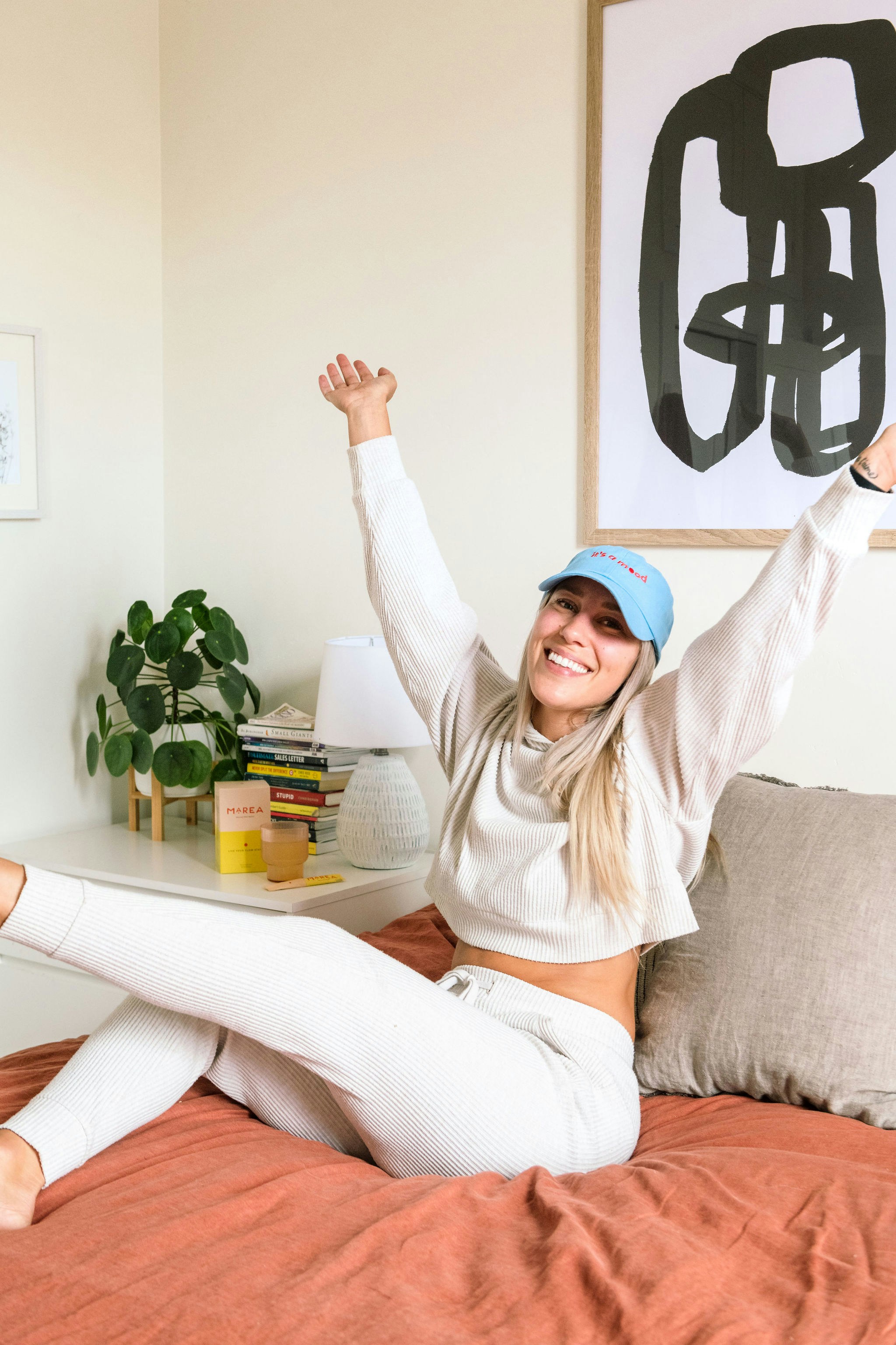 Woman sitting on the couch with her arms up
