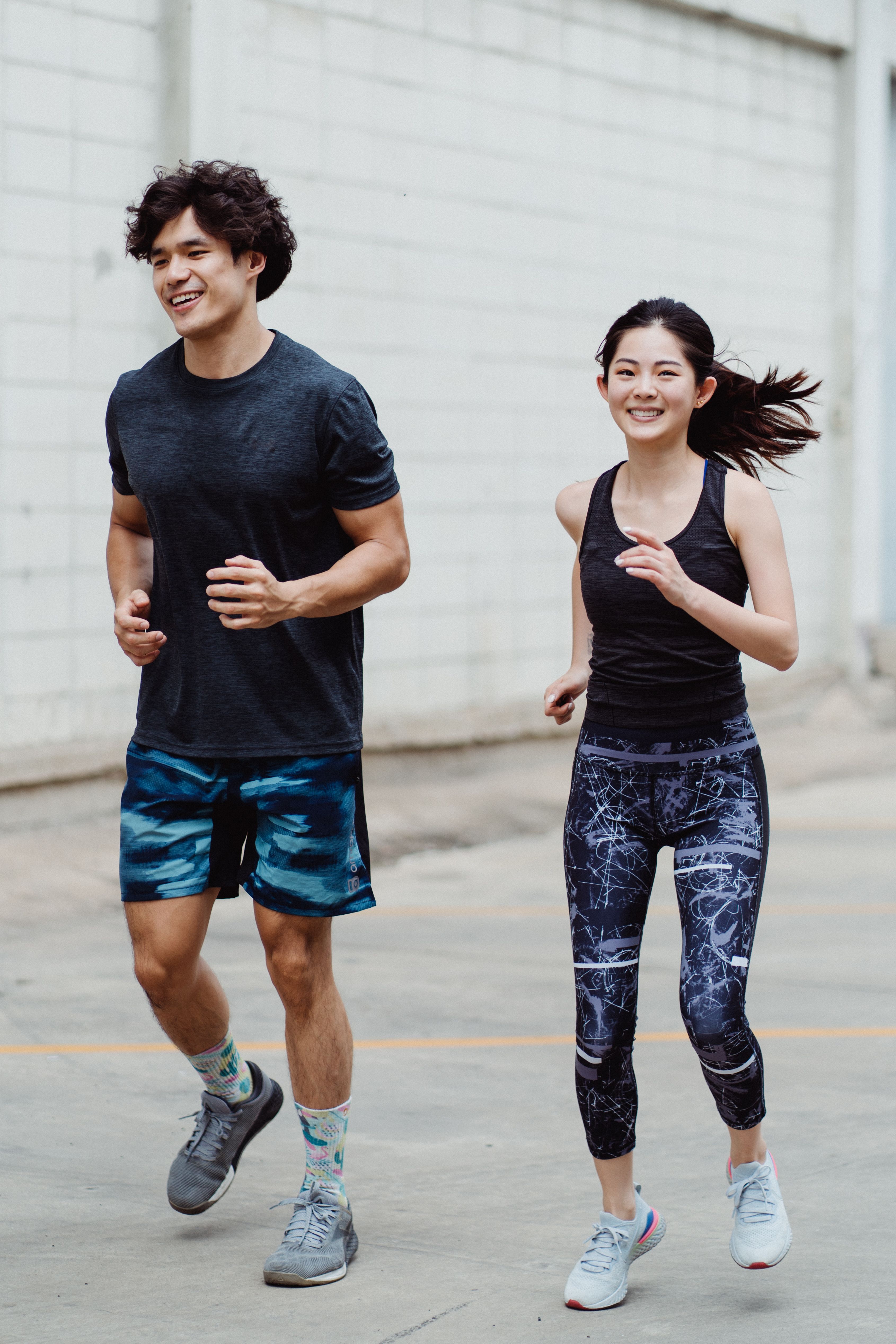 Man and woman running outside stock image