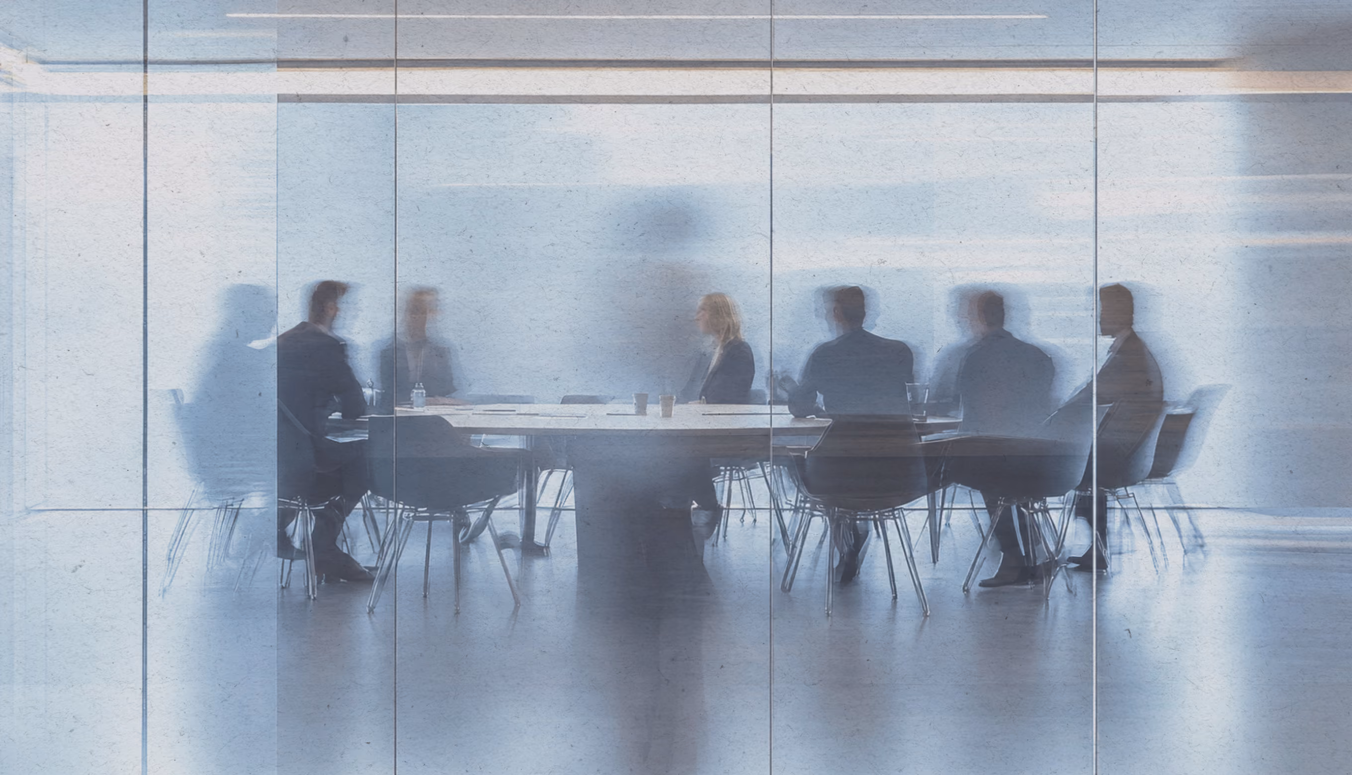 People sitting around a desk in a corporate setting