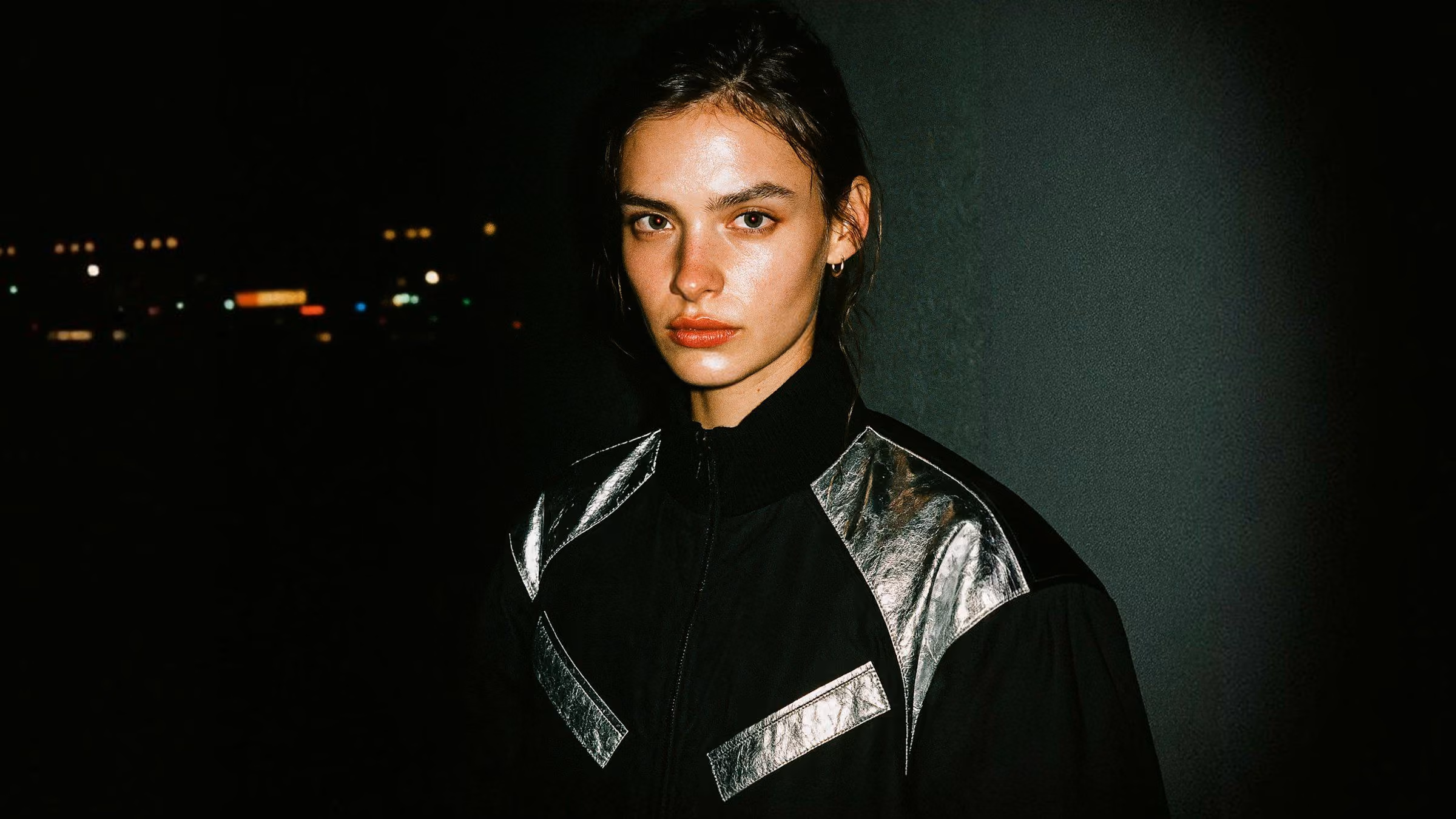 Photo of a woman in a black jacket at night