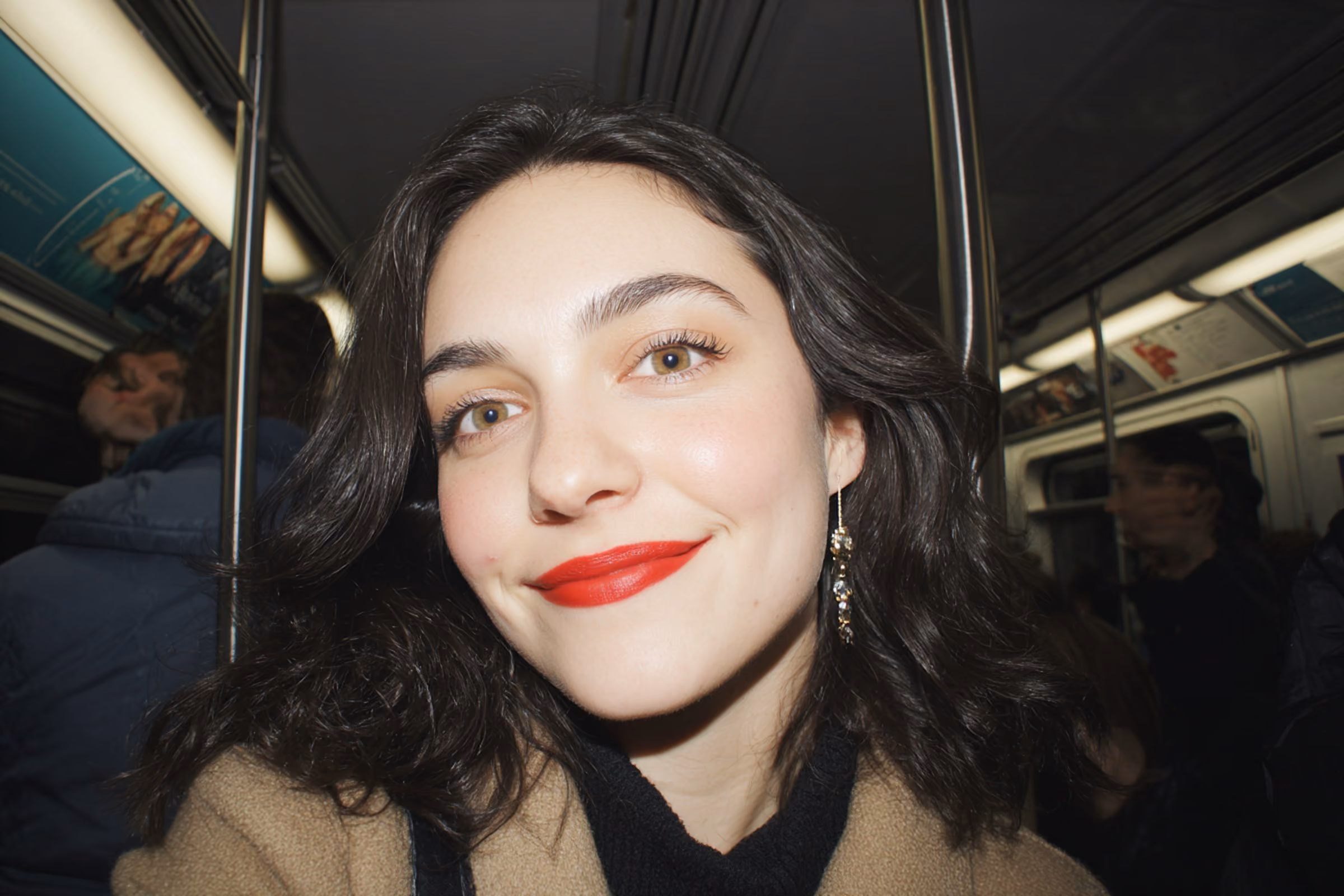 Photo of a smiling woman with red lipstick