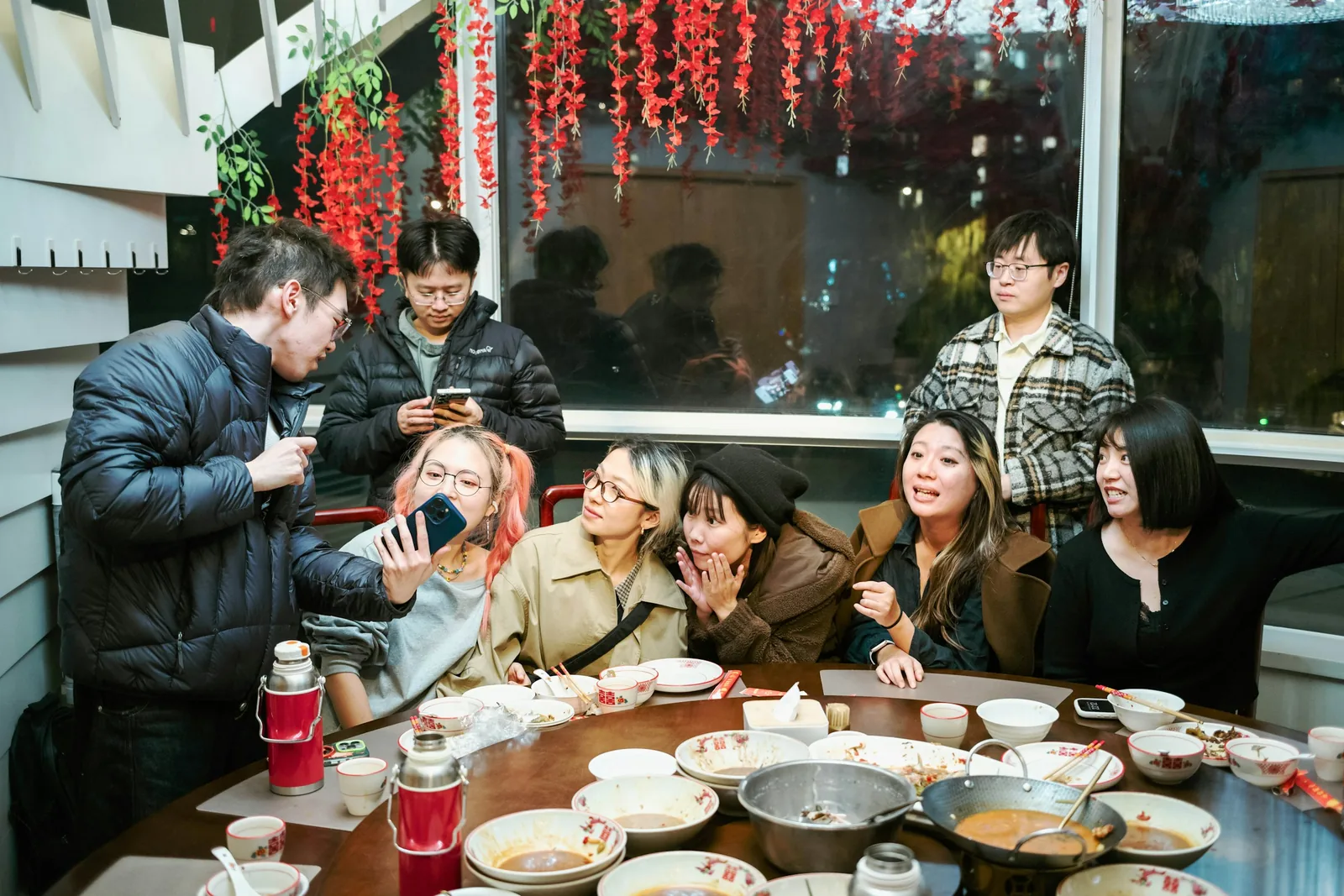 Photo of friends laughing around a table after dinner