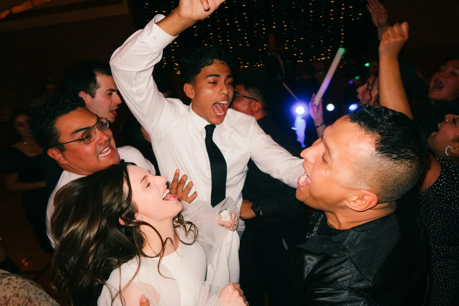 Photo of friends dancing and cheering at a party