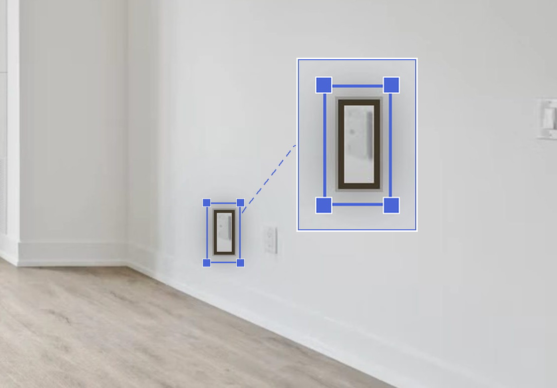 A box drawn round a light switch on a photo of a room, shown magnified - the known size Curate works the proportions from.
