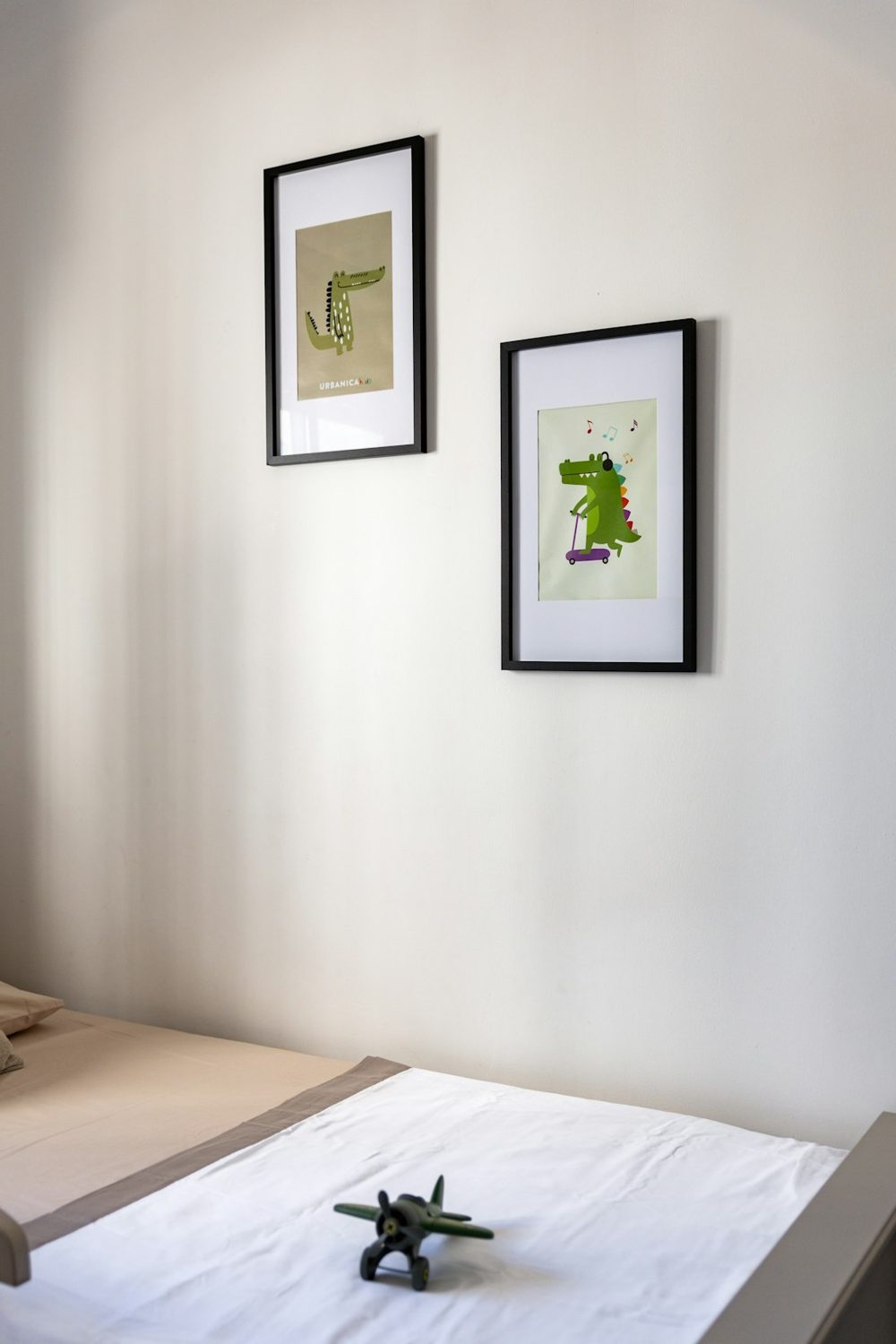 Two framed drawings of alligators hang on wall