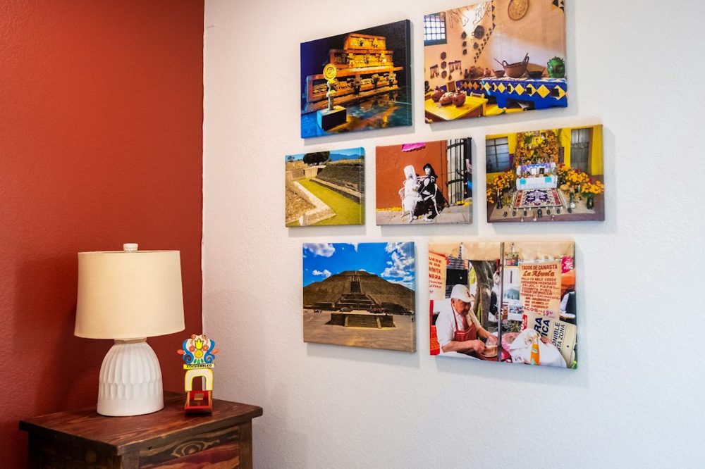 A wall with a lamp and pictures on it