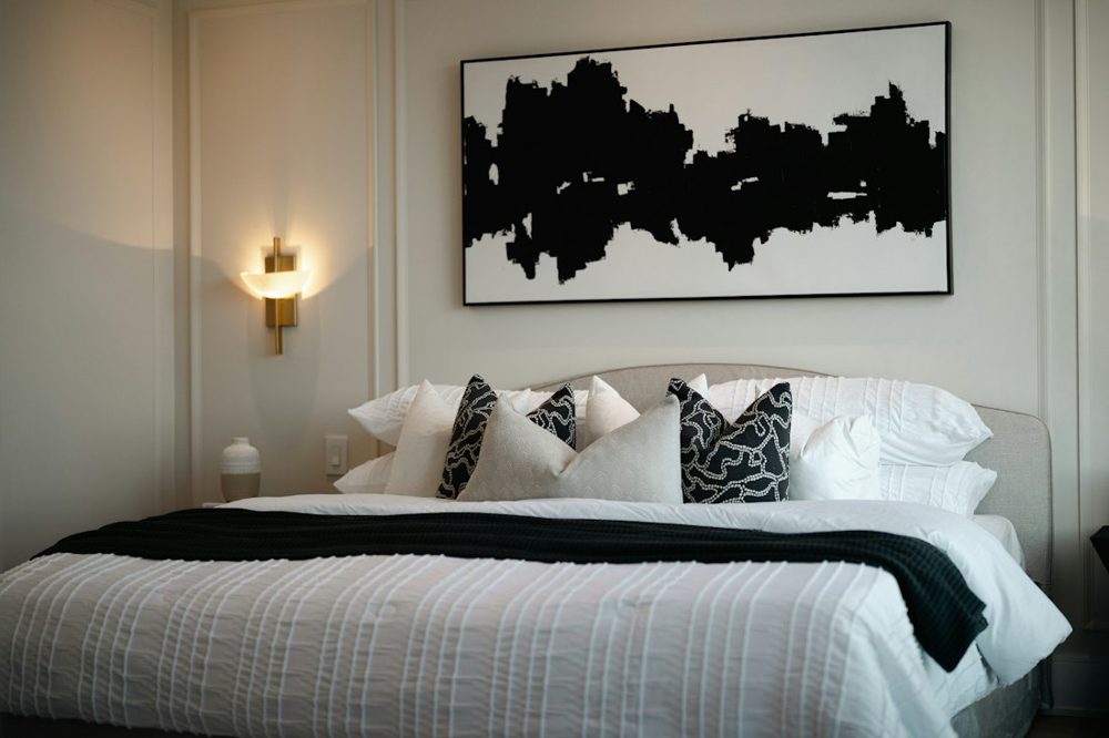Modern bedroom with abstract art above bed