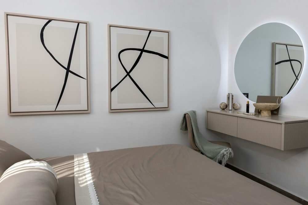 Minimalist bedroom with abstract art and vanity