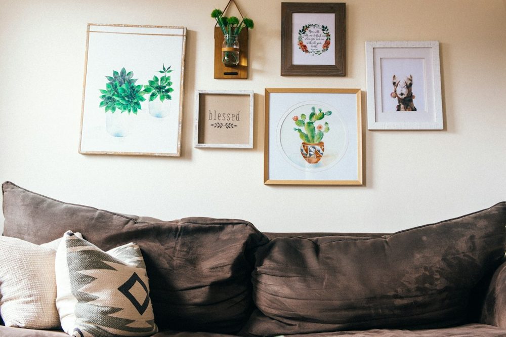 White and green floral wall decor above a sofa