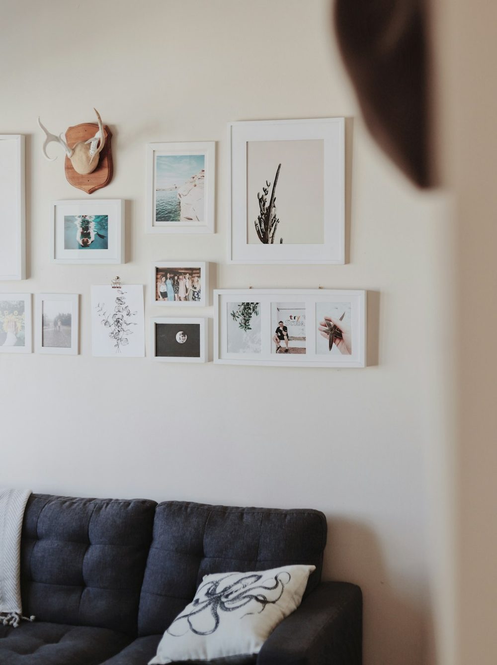 White wall with a cluster of photo frames