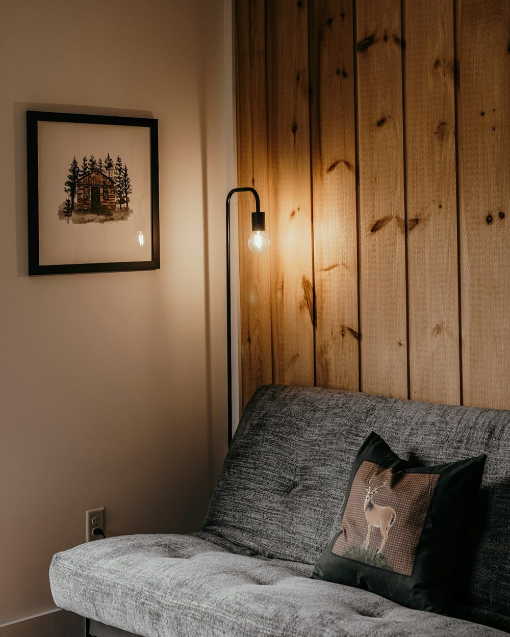 A living room with a couch and a picture on the wall