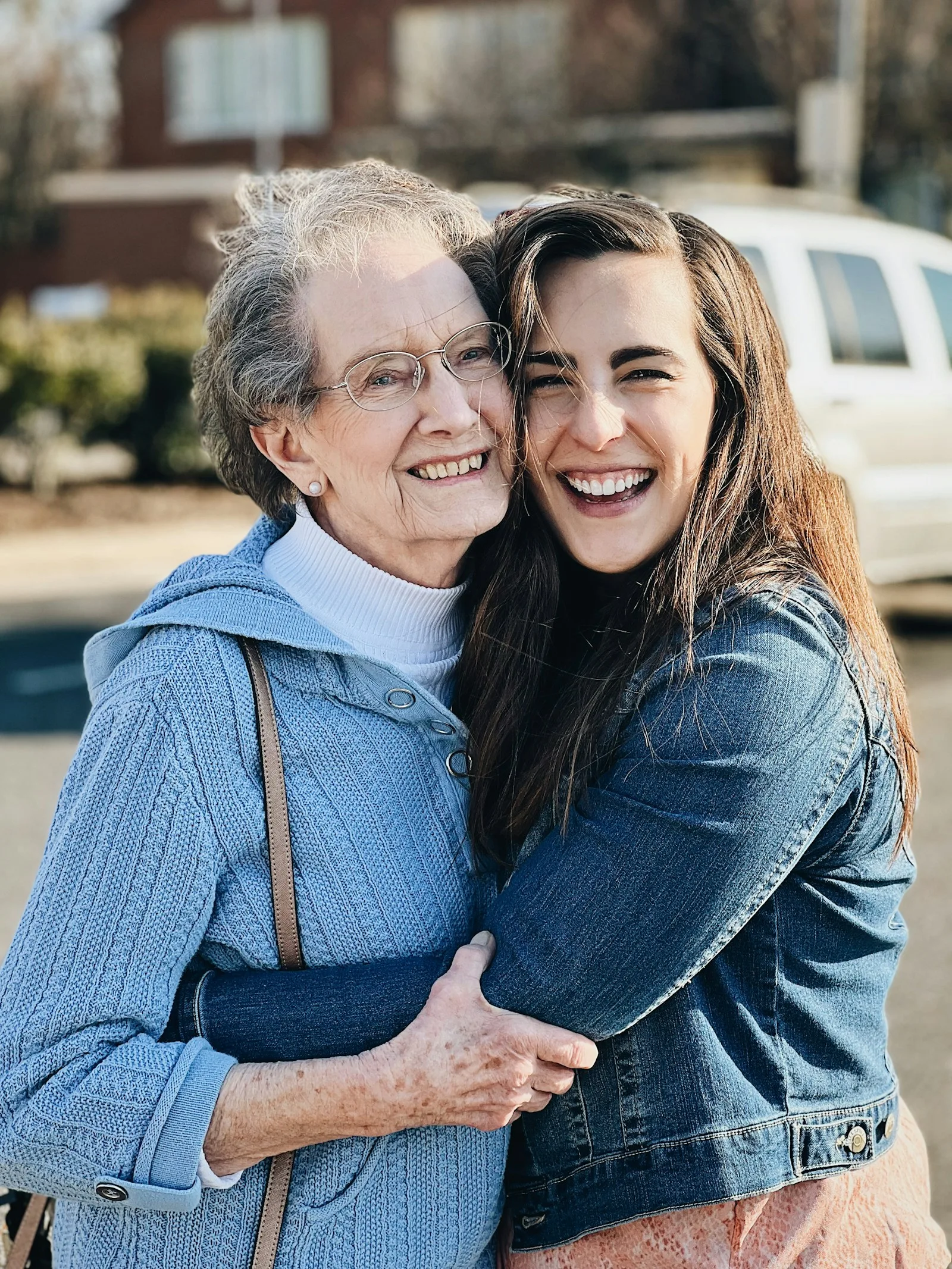 Grandmother and granddaughter hugging and laughing