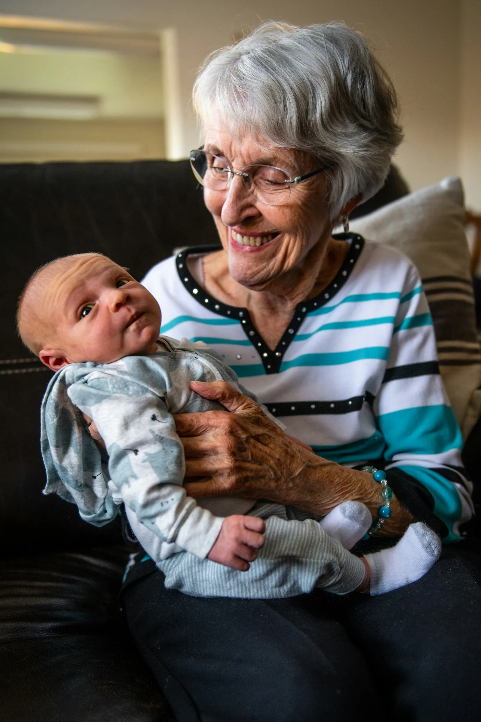Great-grandmother holding a newborn baby