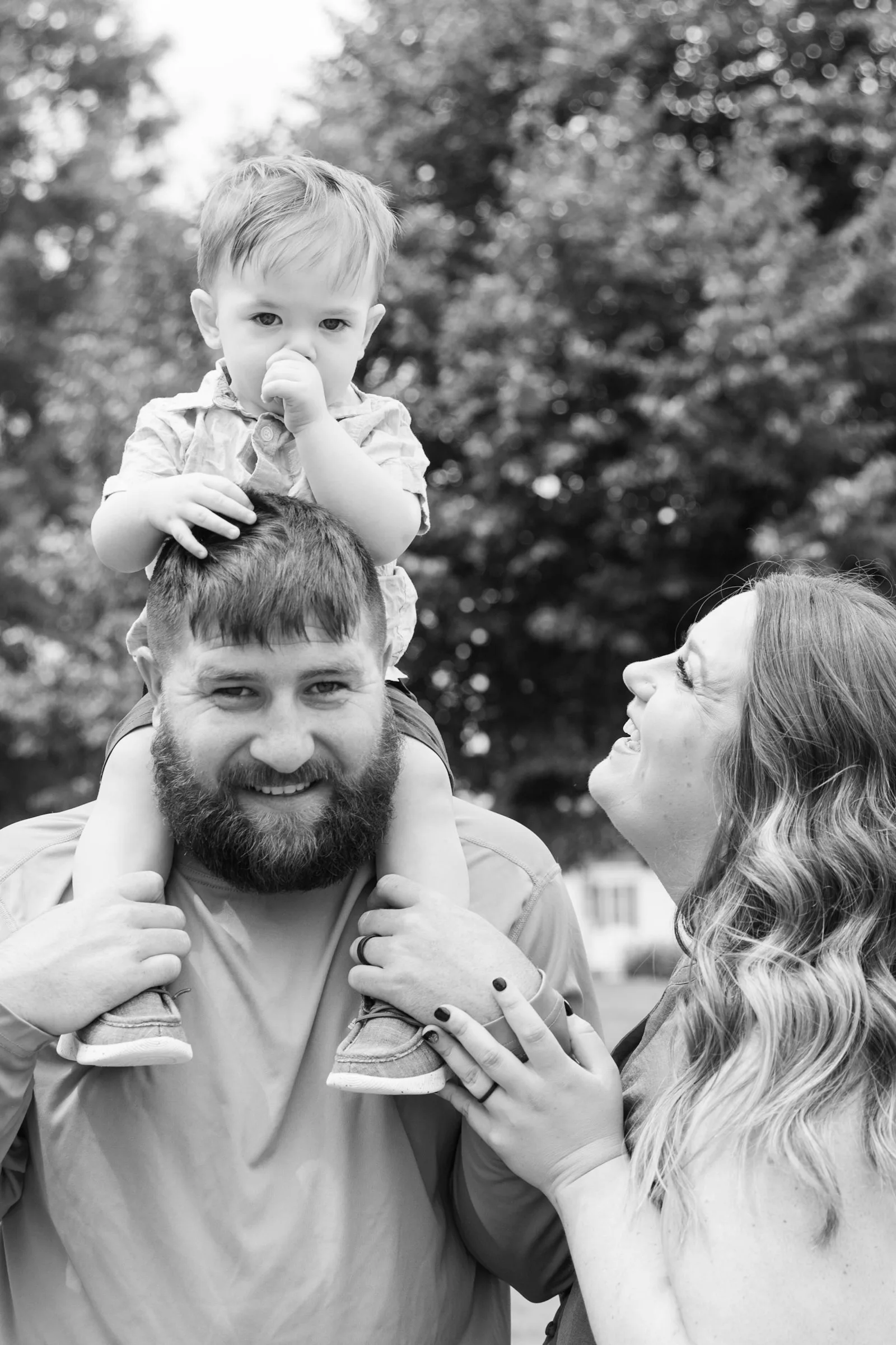 Black and white photo of a father holding his baby