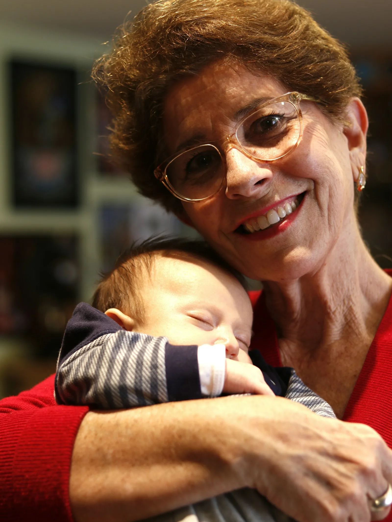 Grandmother cuddling a sleeping baby