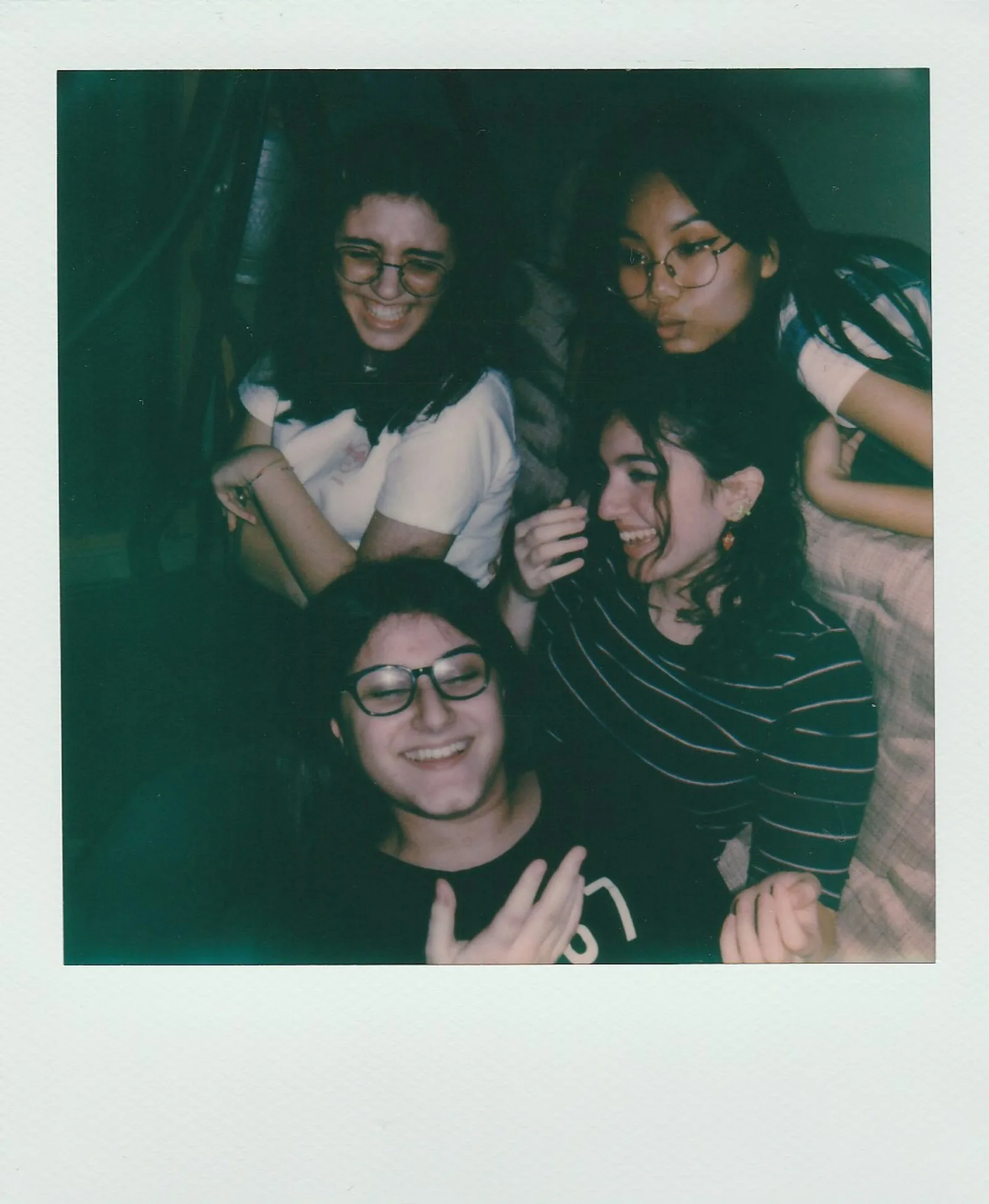 Instant photo of three friends laughing together