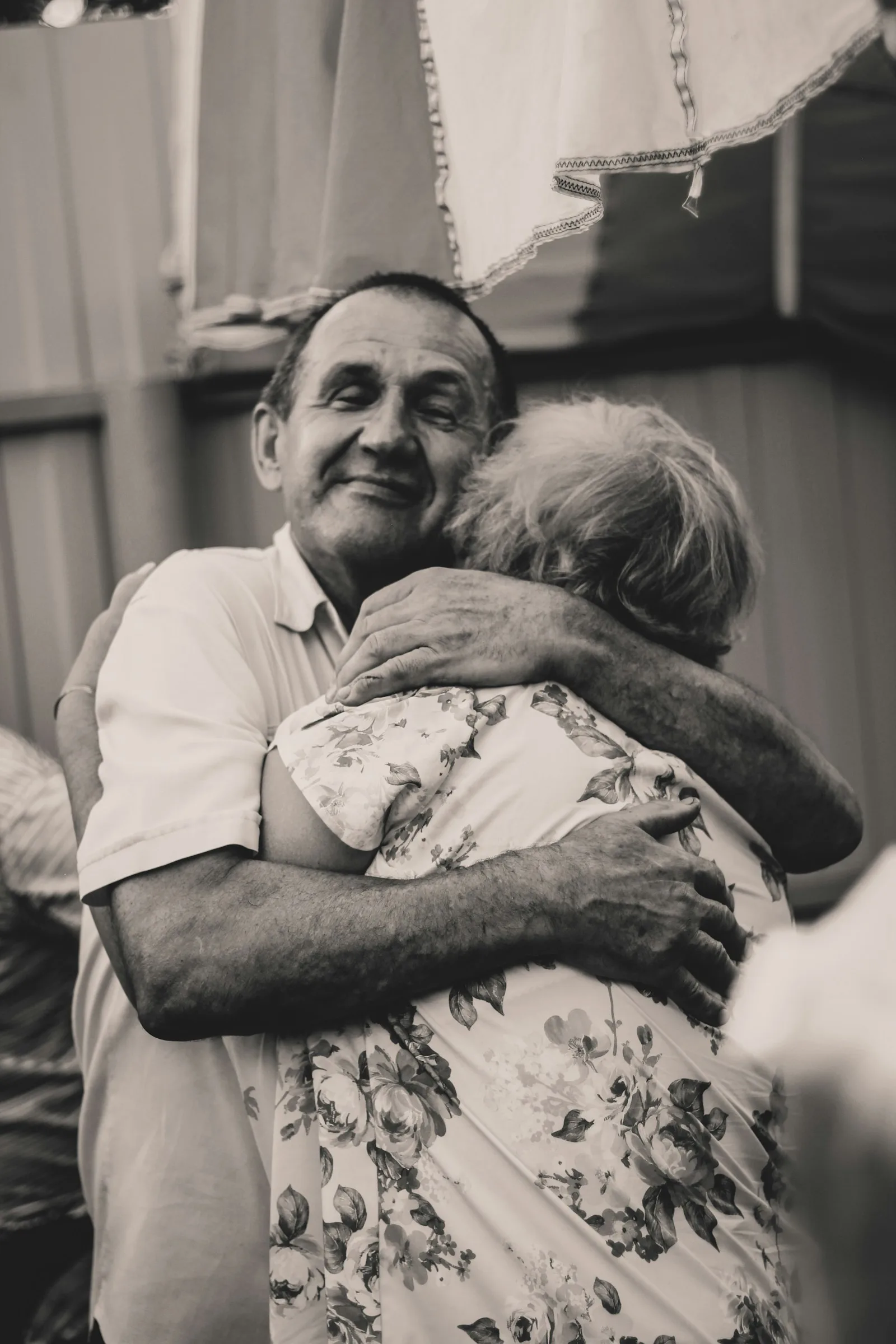 Black and white photo of a father and grown-up daughter embracing