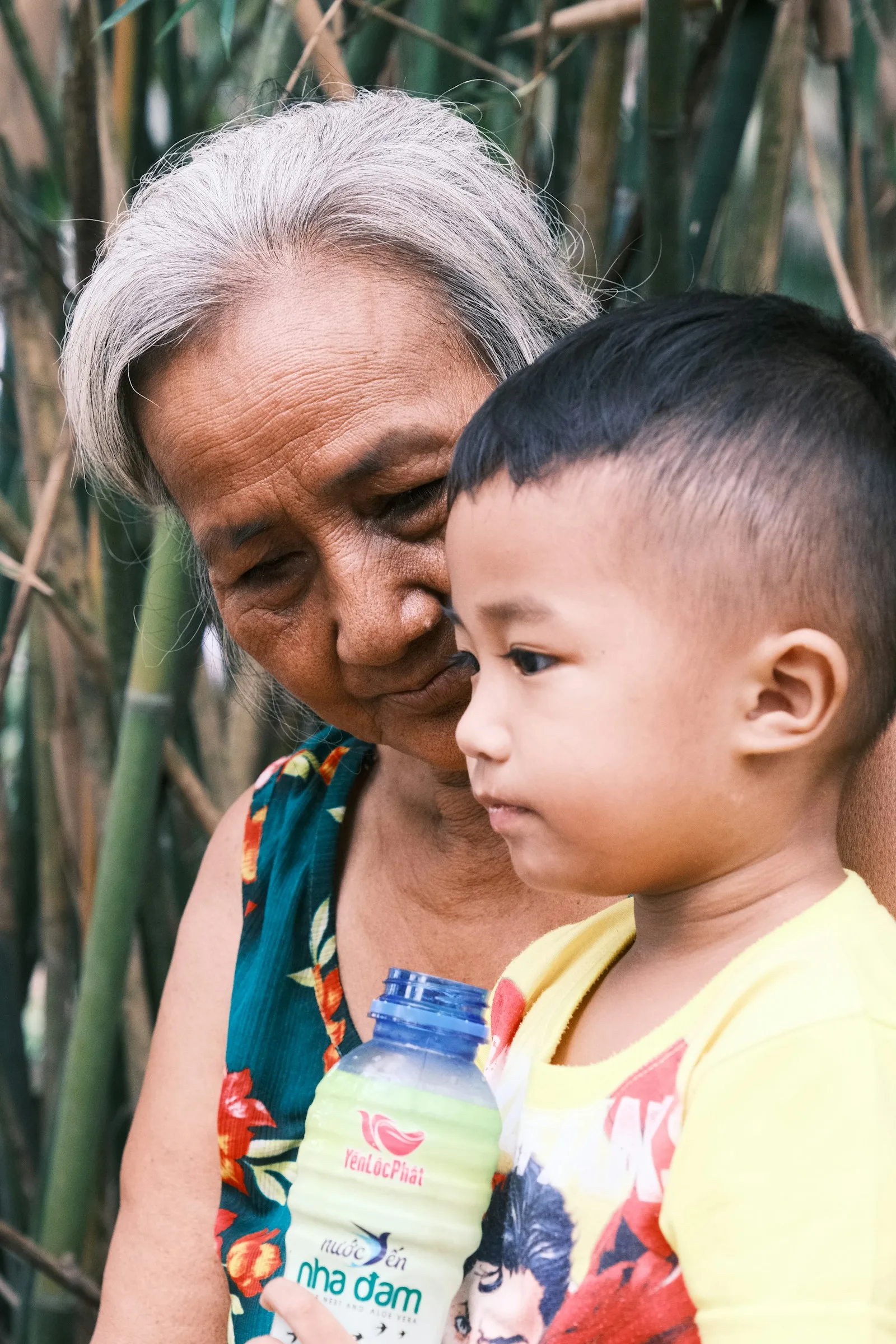 Grandmother holding her young grandson