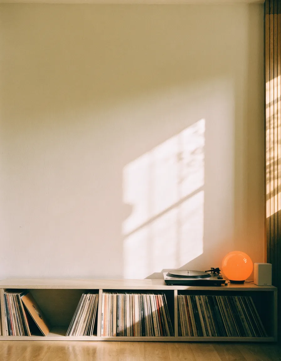 Empty living room wall above a low record shelf