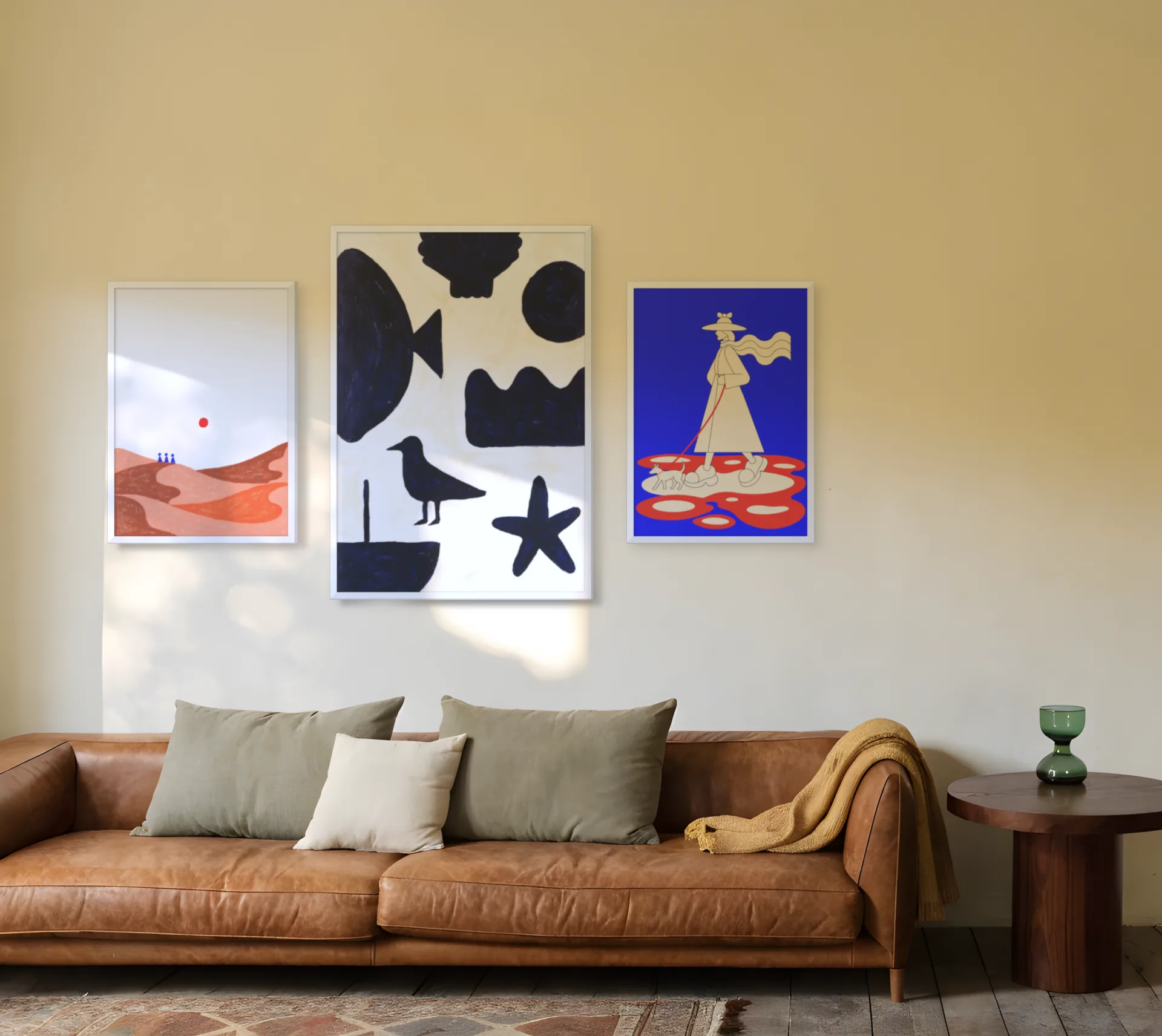 Coastal gallery wall template: a large print flanked by two smaller ones above a sofa in a living room
