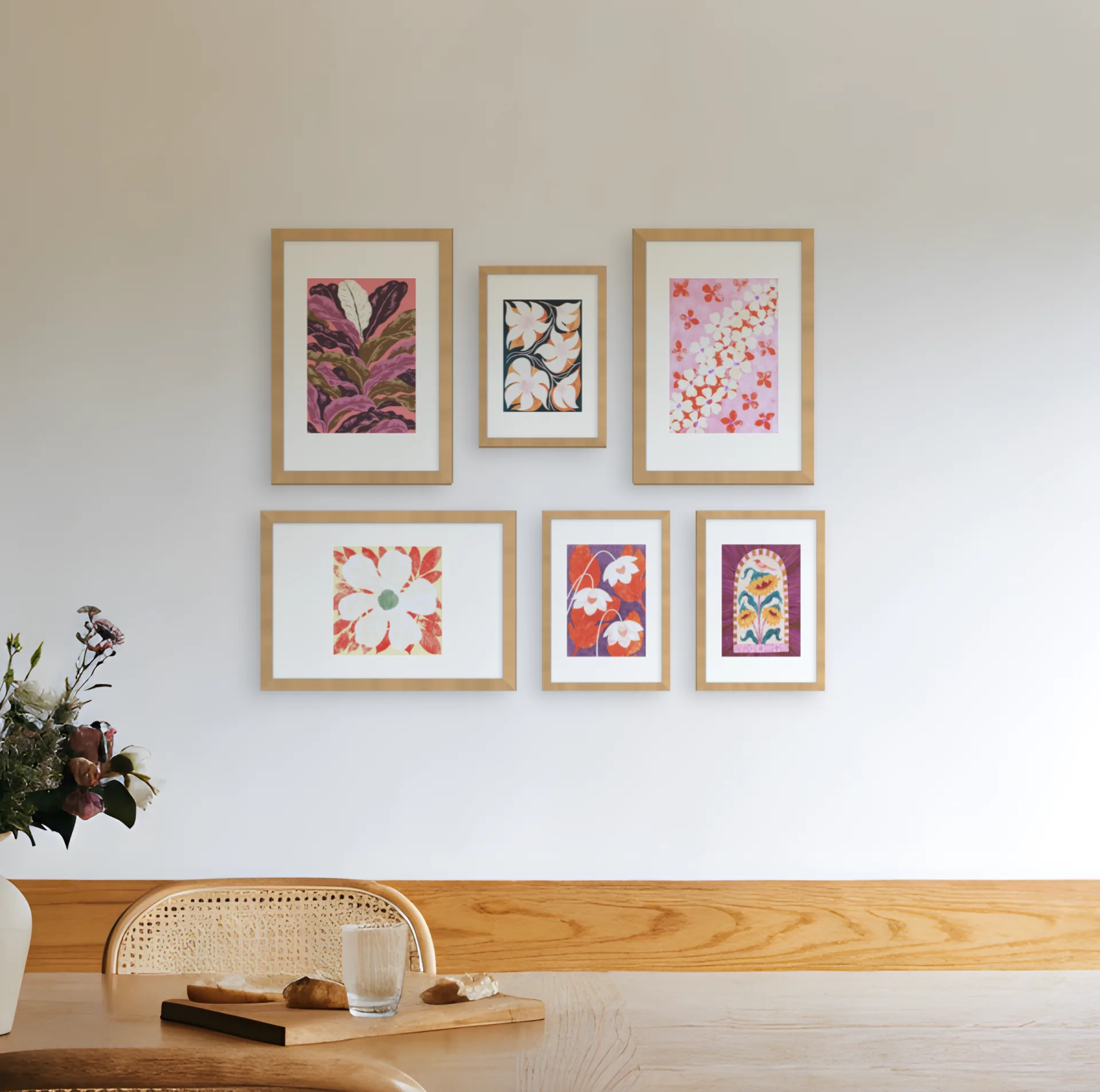 Botanical gallery wall template: six framed botanical prints in a salon arrangement above a bench in a dining room