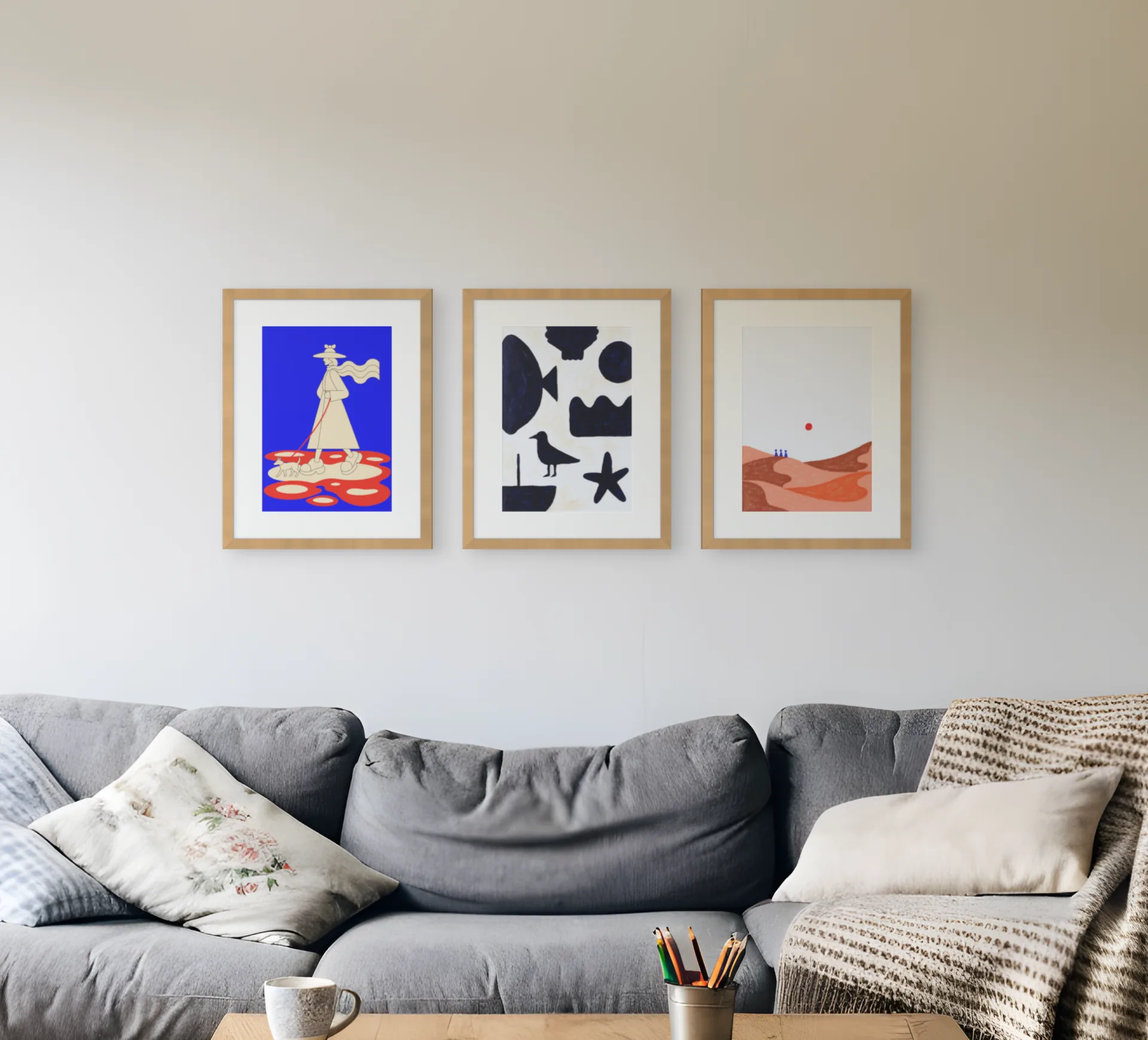 Three 40 by 50 cm prints hung in a row at 6 cm gaps above a sofa