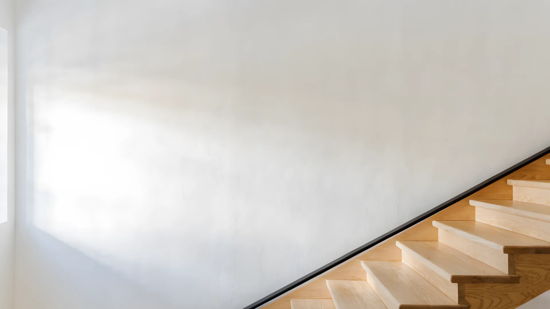 An empty staircase wall, before any frames go up