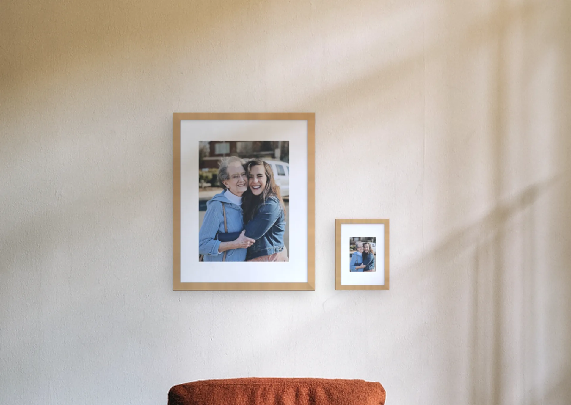 The same family photo printed twice on one wall, large at 16x20 in (40x50 cm) and small at 6x8 in (15x20 cm)