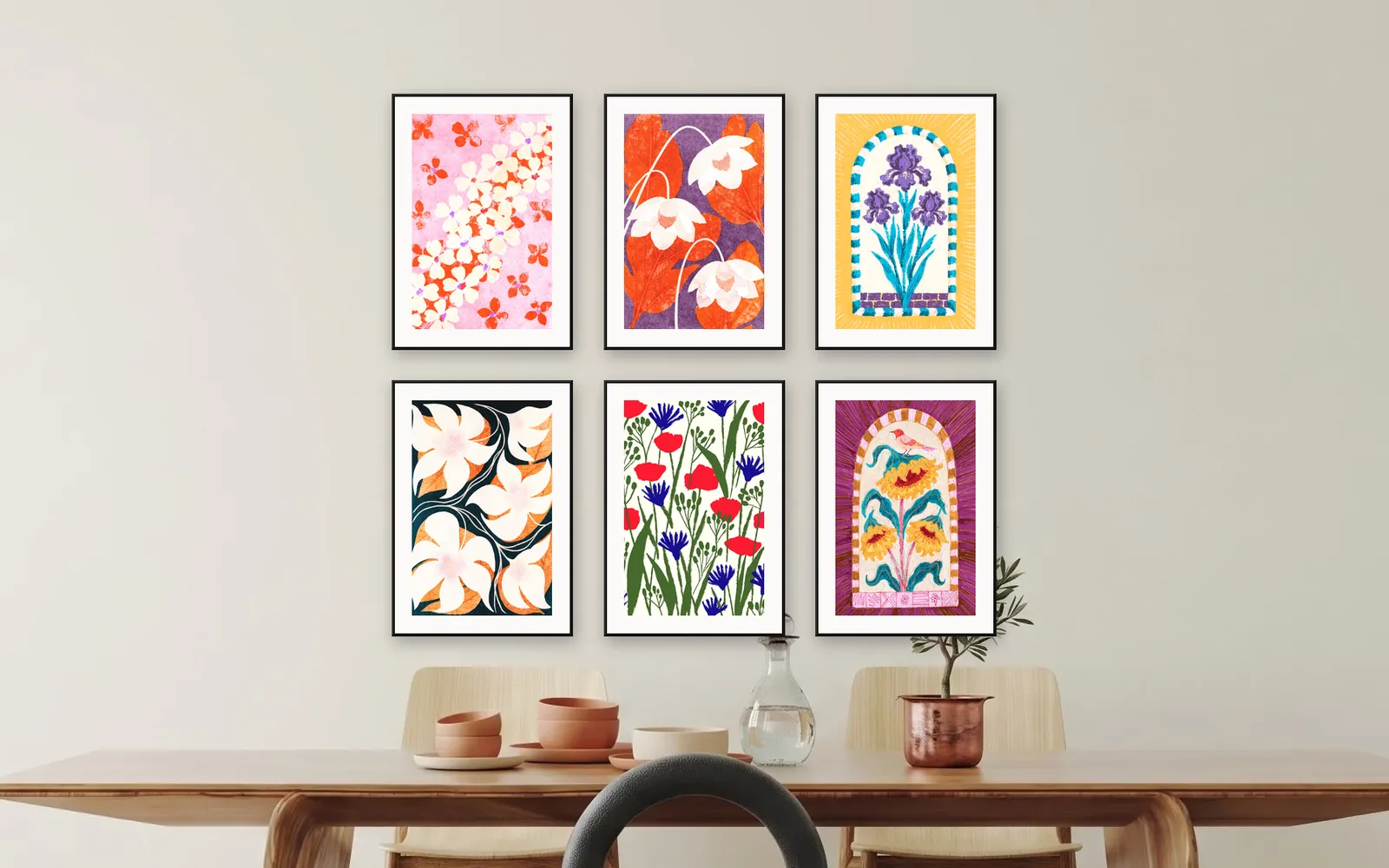 Grid gallery wall layout: six prints in black frames with white mounts, in two even rows above a dining table