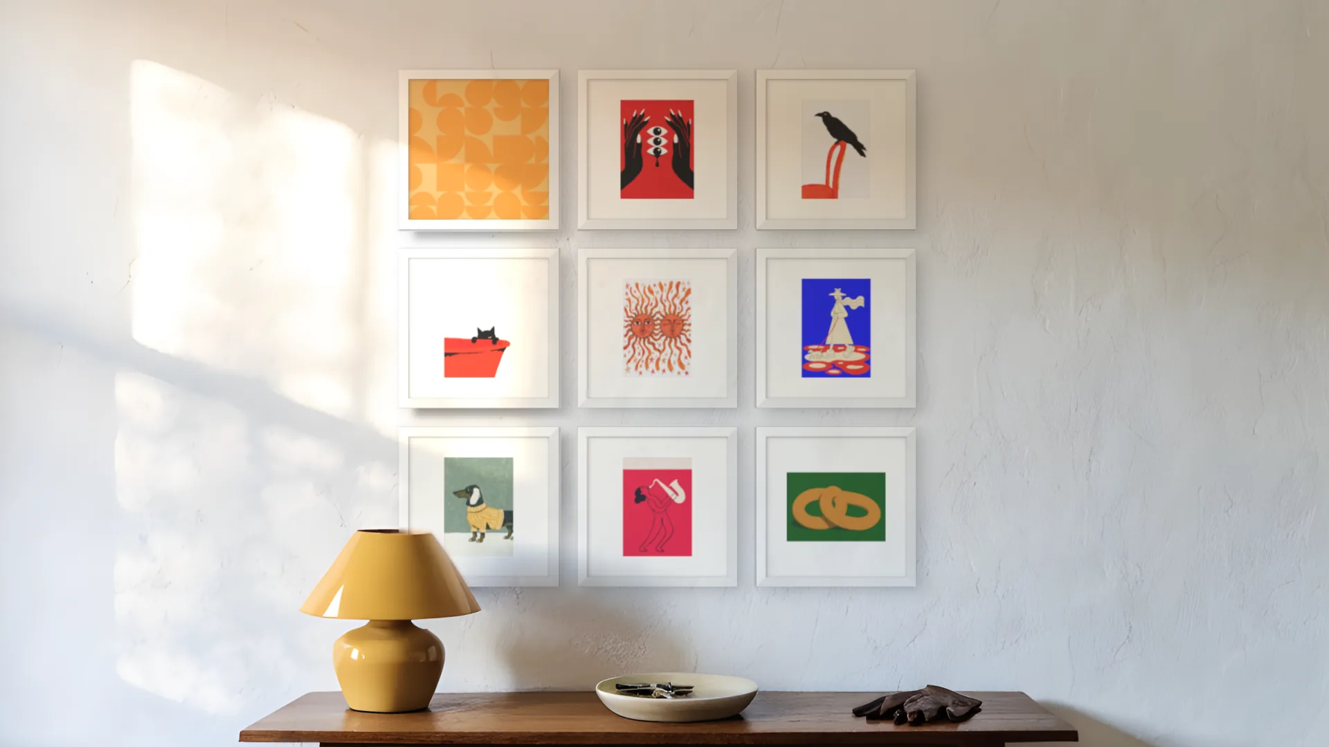 Pop Art gallery wall idea: nine prints in white frames in a three by three grid above a console table in a hallway.