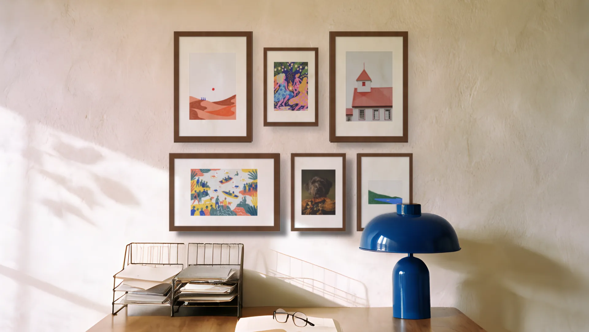 Vintage gallery wall idea: six prints in walnut frames in a salon arrangement above a desk in a home office.