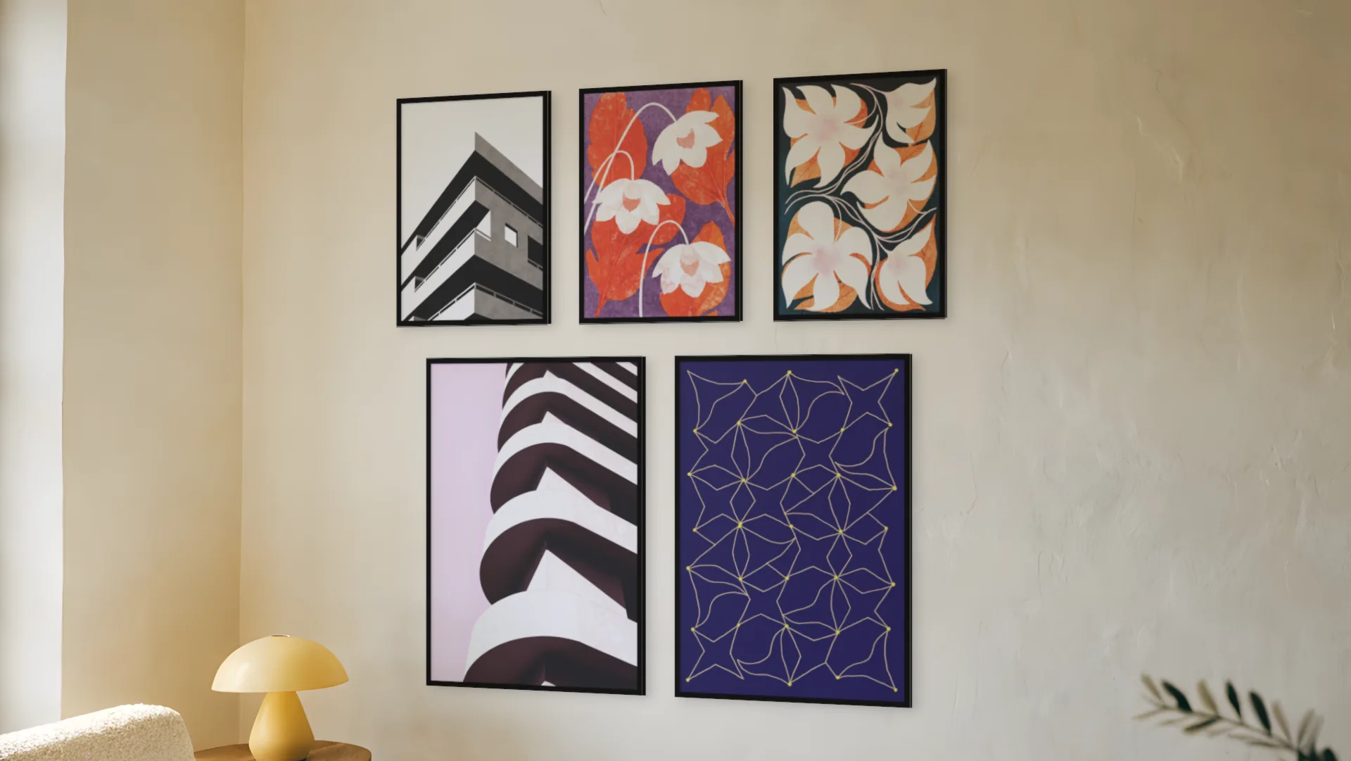 Moody gallery wall idea: five prints in black frames in a statement layout on a living room wall.
