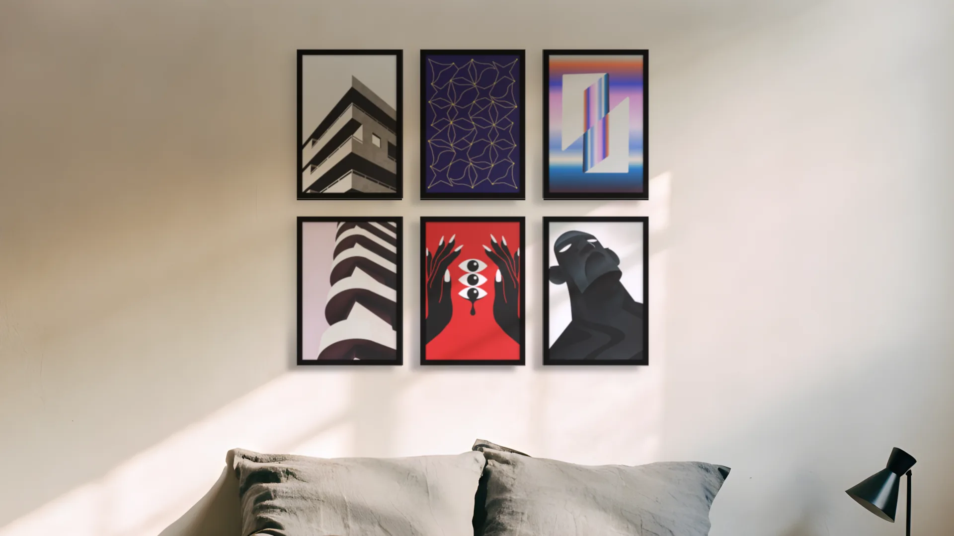 Contemporary gallery wall idea: six prints in black frames in a two by three grid above a bed in a bedroom.