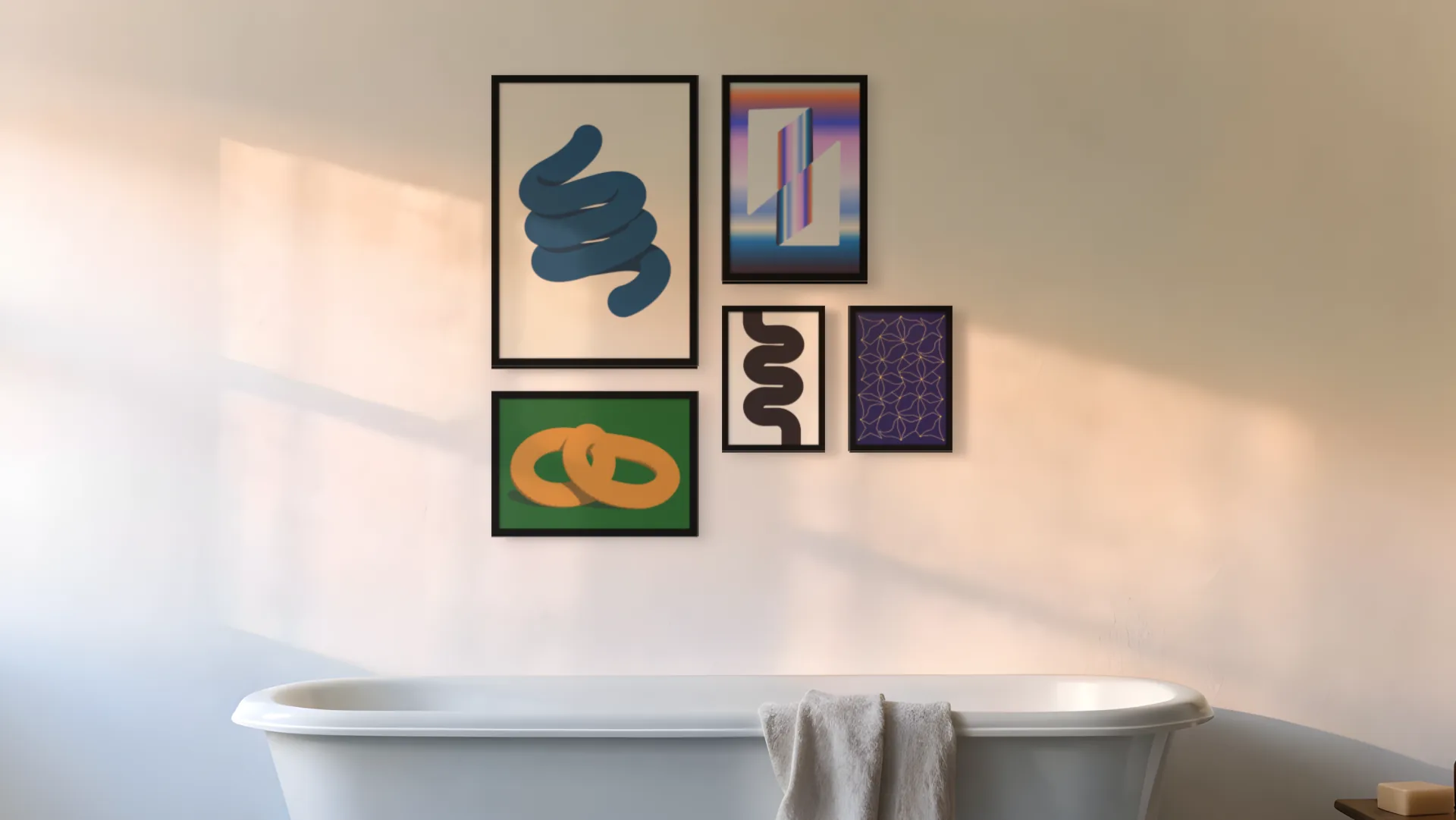 Abstract gallery wall idea: five prints in black frames in an asymmetric layout above a bath in a bathroom.