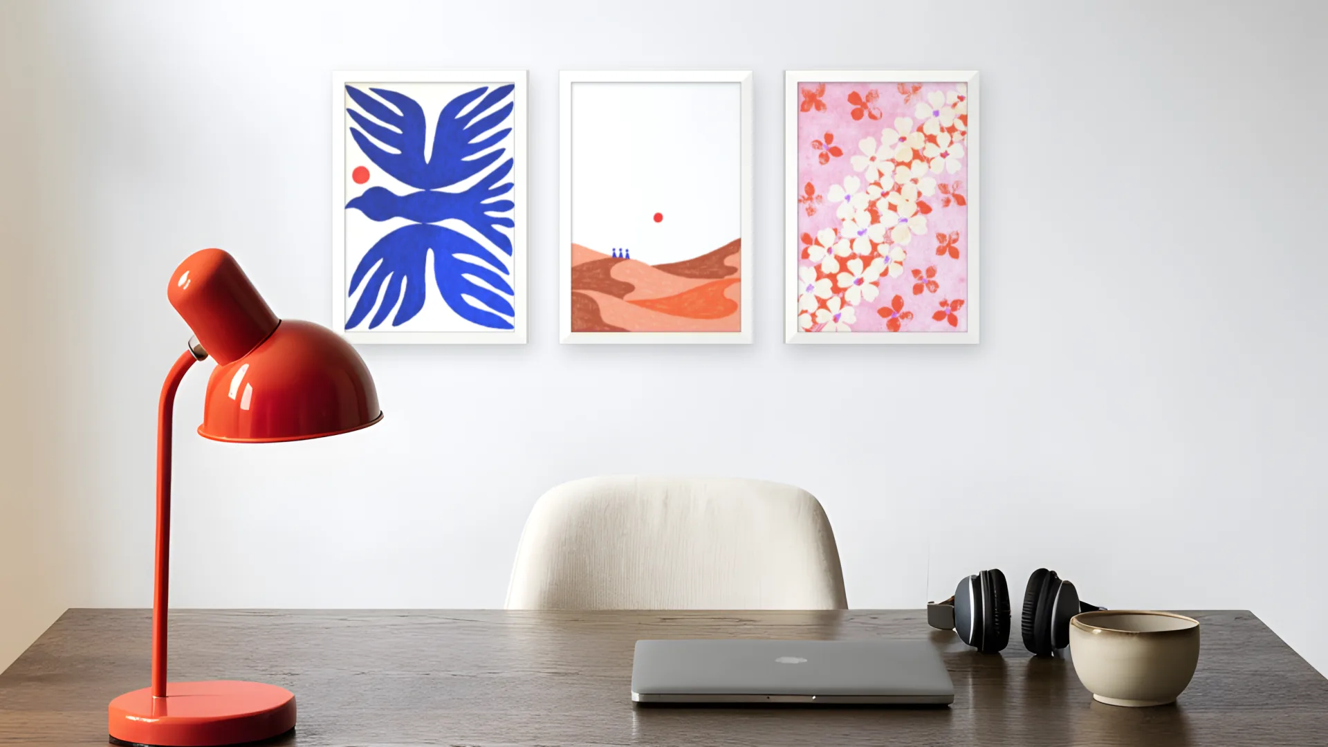 Scandi gallery wall idea: three prints in white frames in a row above a desk in a home office.