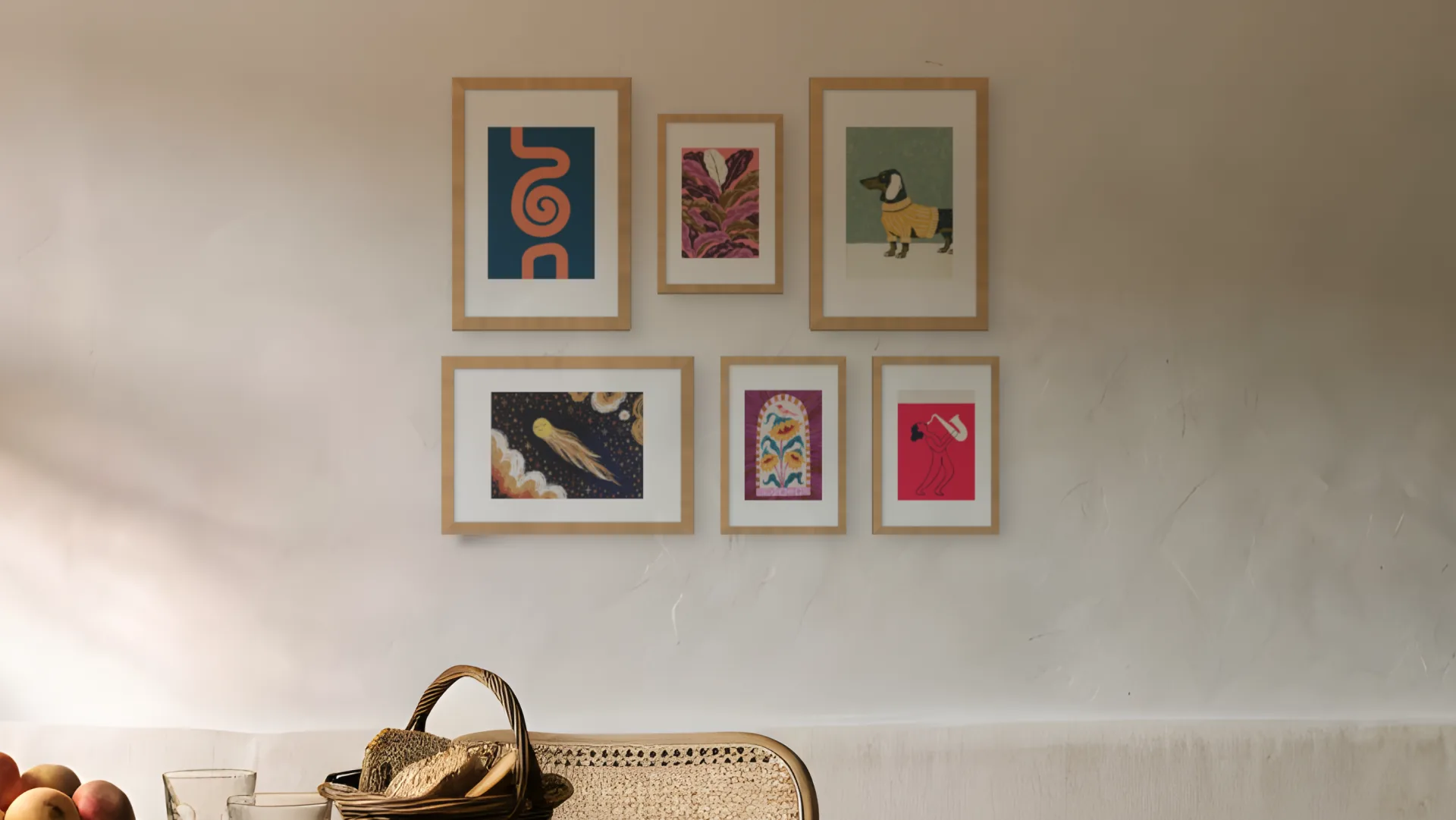 Dining room gallery wall idea: six prints in oak frames in a salon arrangement above a bench in a kitchen-diner.
