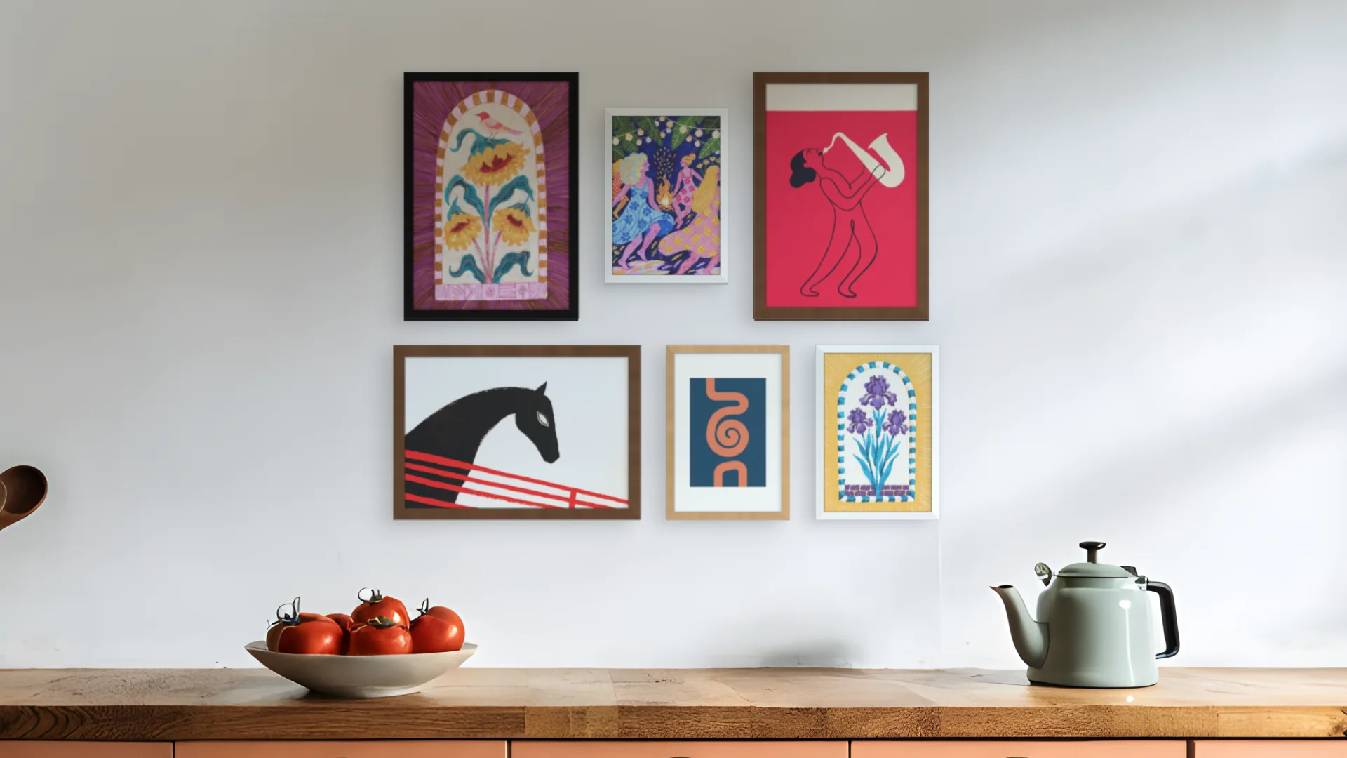 Eclectic gallery wall idea: six framed prints in a salon arrangement above a kitchen worktop.