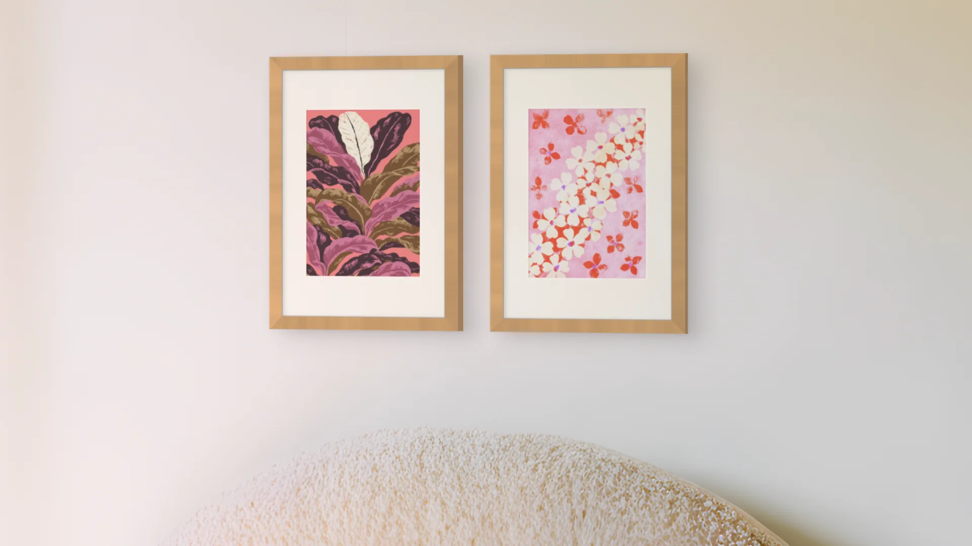 Bedroom gallery wall idea: two prints in oak frames side by side above a bed in a bedroom.