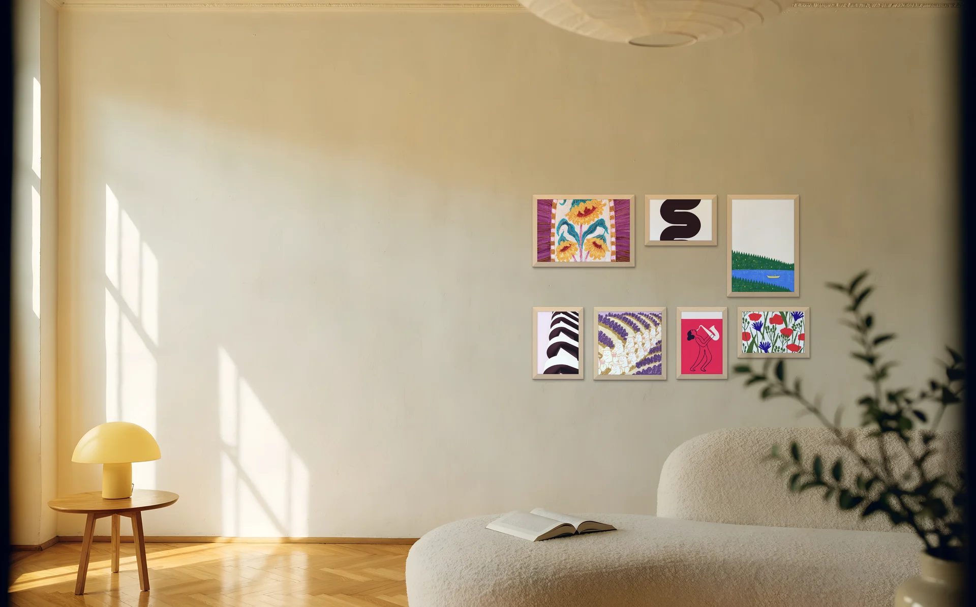 A classic gallery wall of mixed frame sizes above a boucle sofa in a sunny room