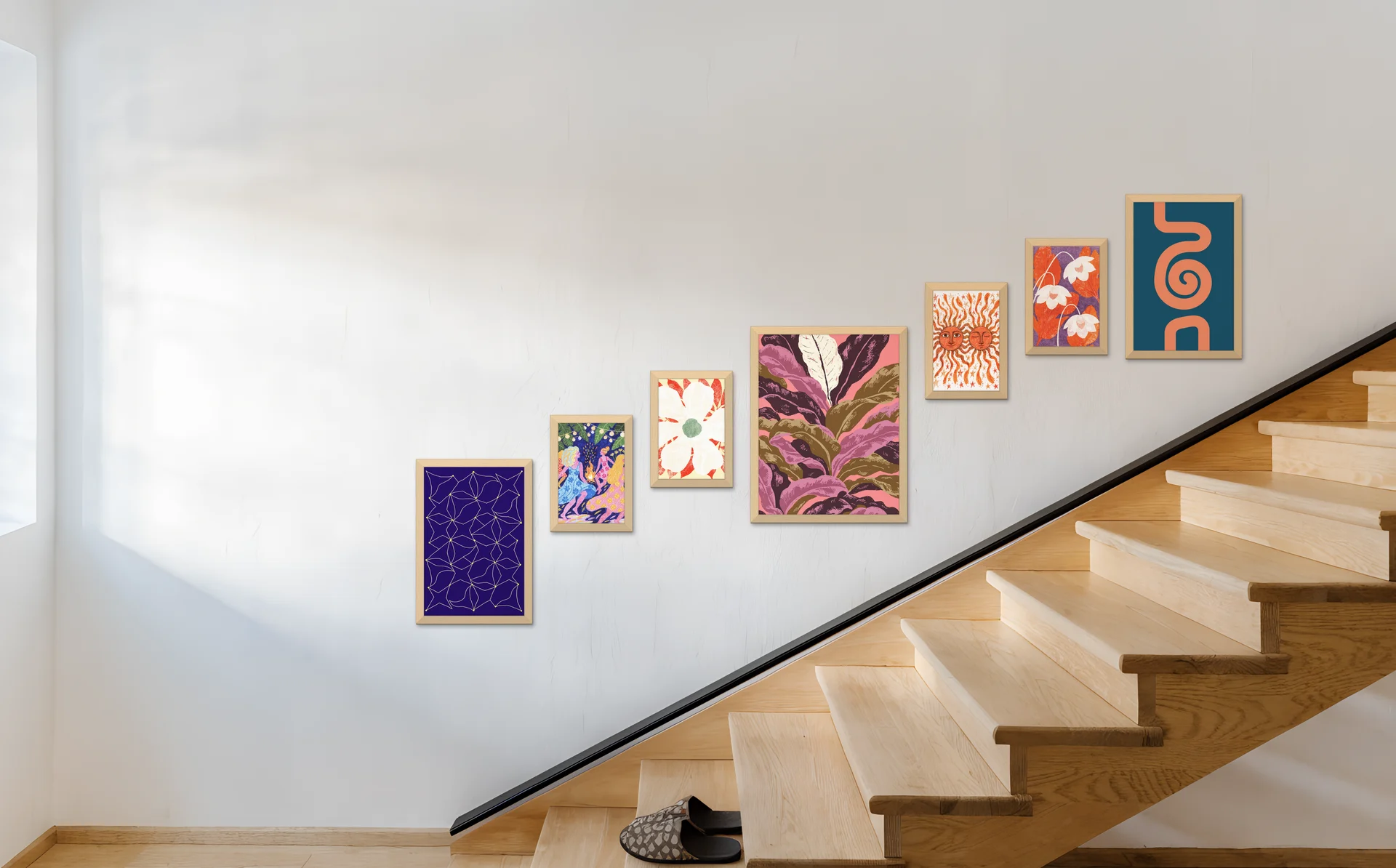 A gallery wall of seven frames rising up a staircase