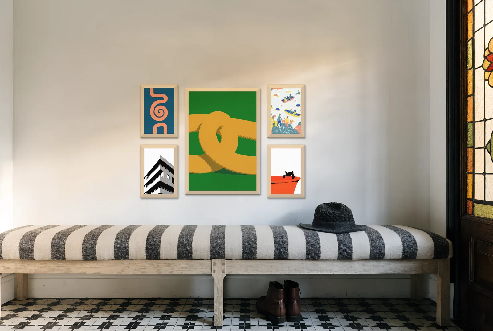 The centred gallery wall layout above a striped hallway bench