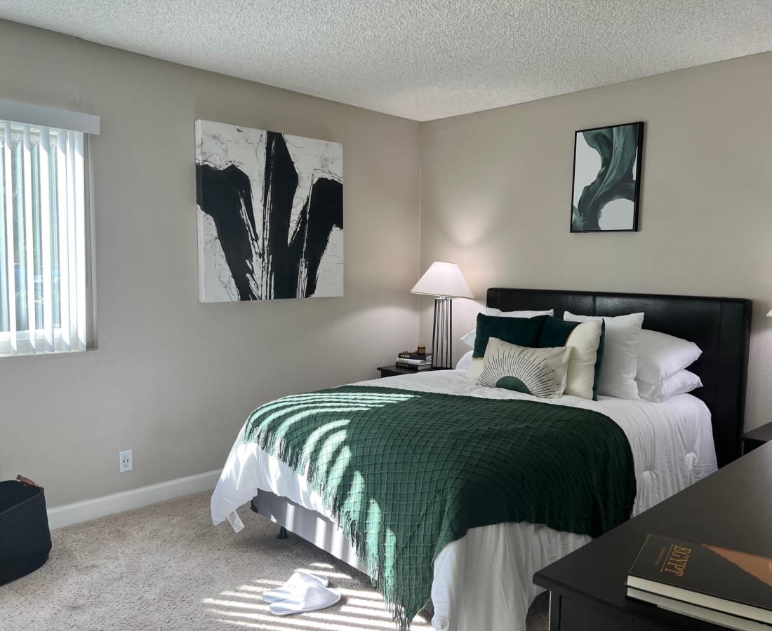 Bedroom with bed, wall art, and large window