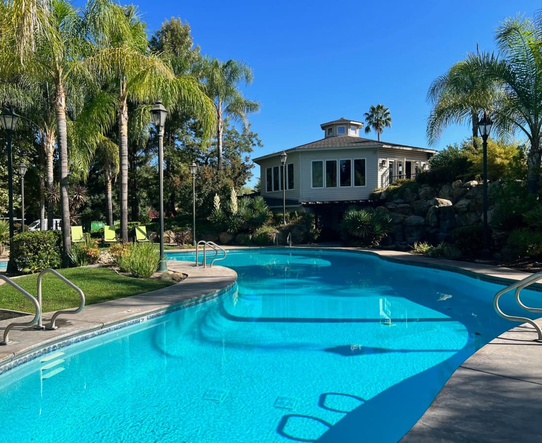 Swimming pool with lounge chairs and view of exterior