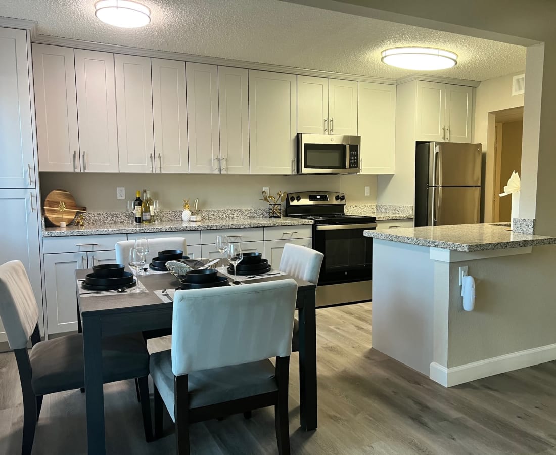 Dining room wit table and chairs and view of kitchen