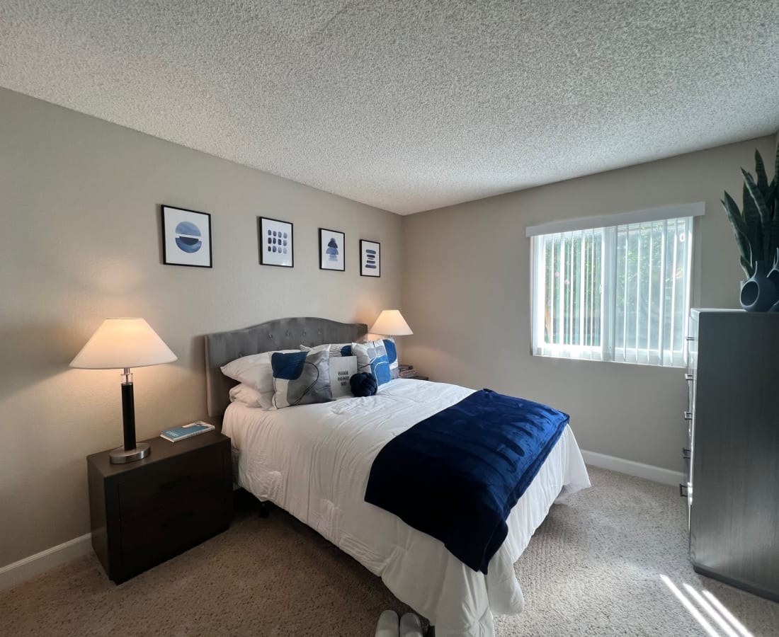 Bedroom with bed, wall art, and large window