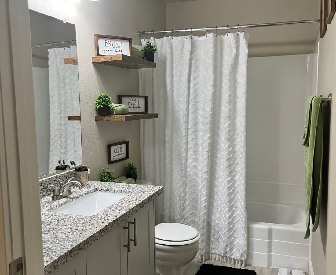 Bathroom with white cabinets and vanity with shower tub combo