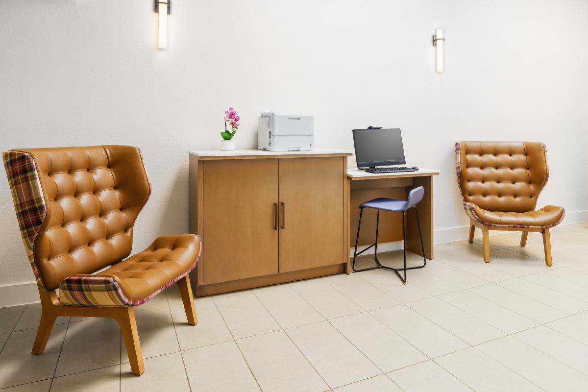 business center with printer, leather chairs and computer