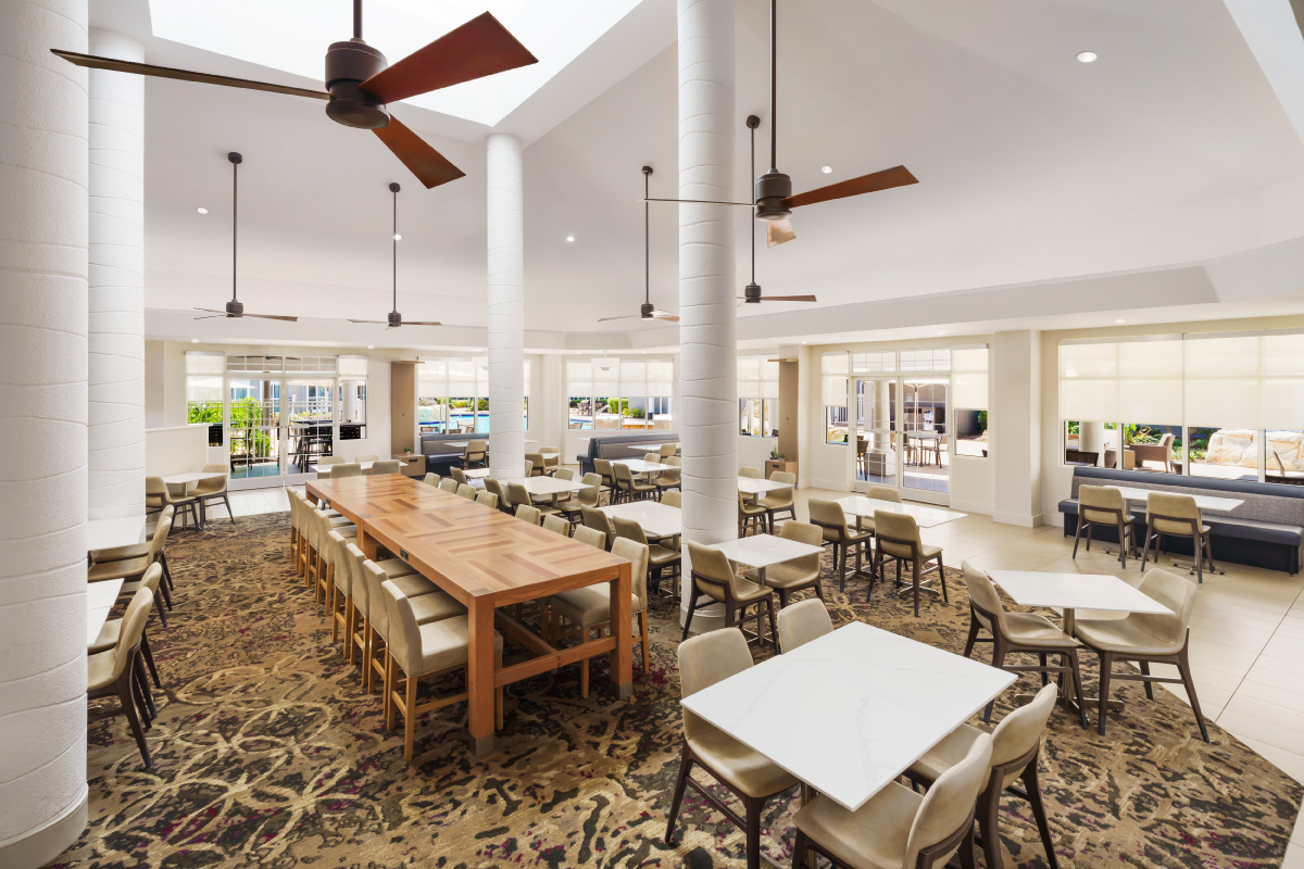 dining room with high ceilings, pillars and modern fans
